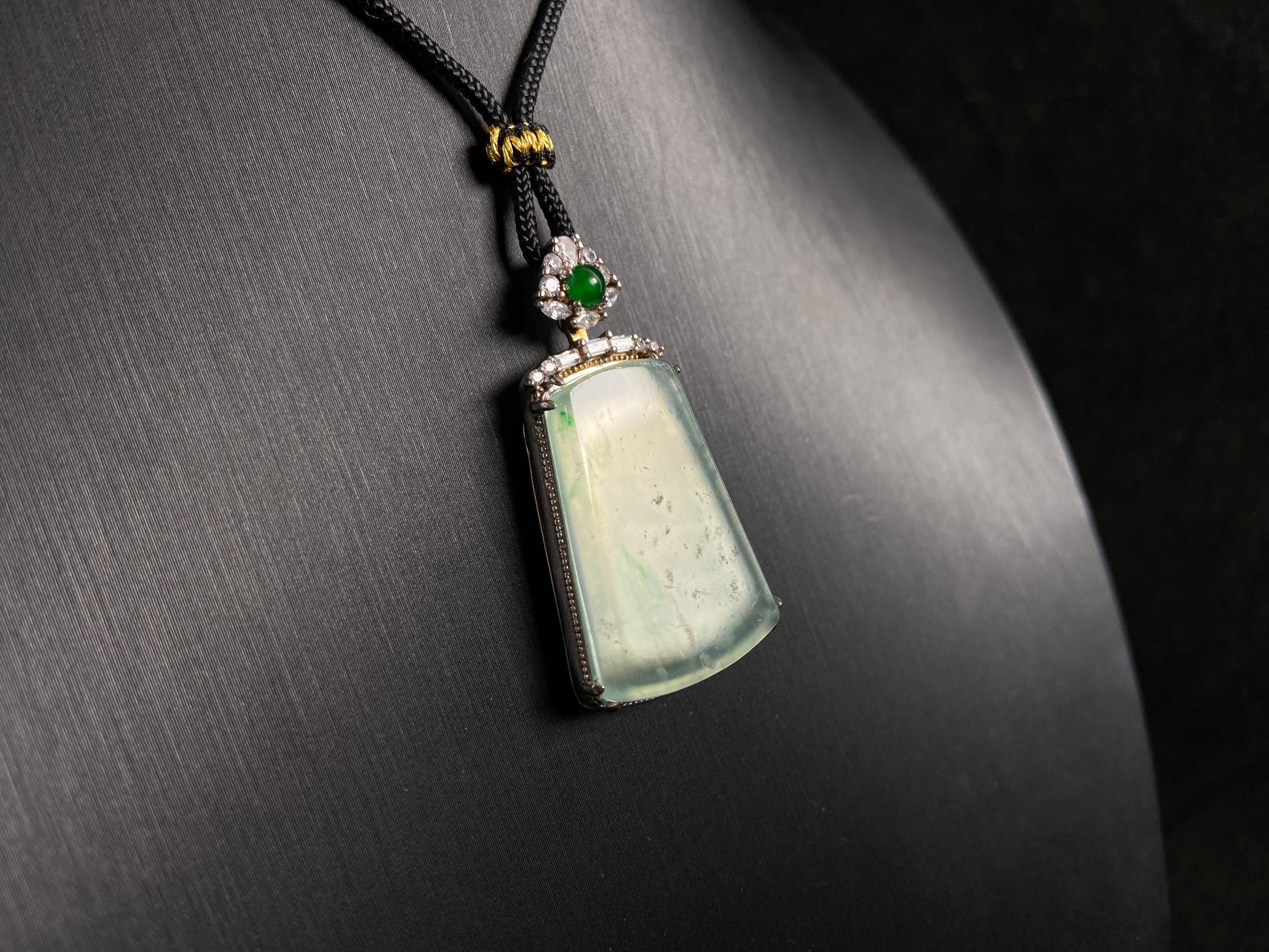 A clear light green "Wu Shi" plaque pendant, framed in 925 silver.