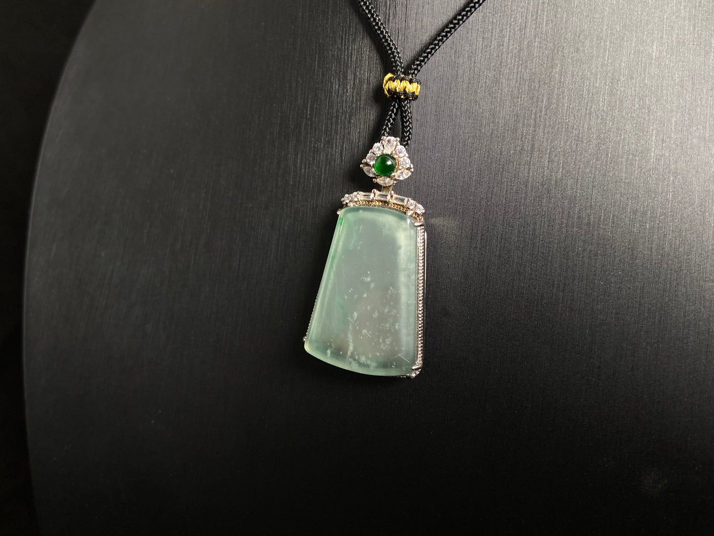 A clear light green "Wu Shi" plaque pendant, framed in 925 silver.