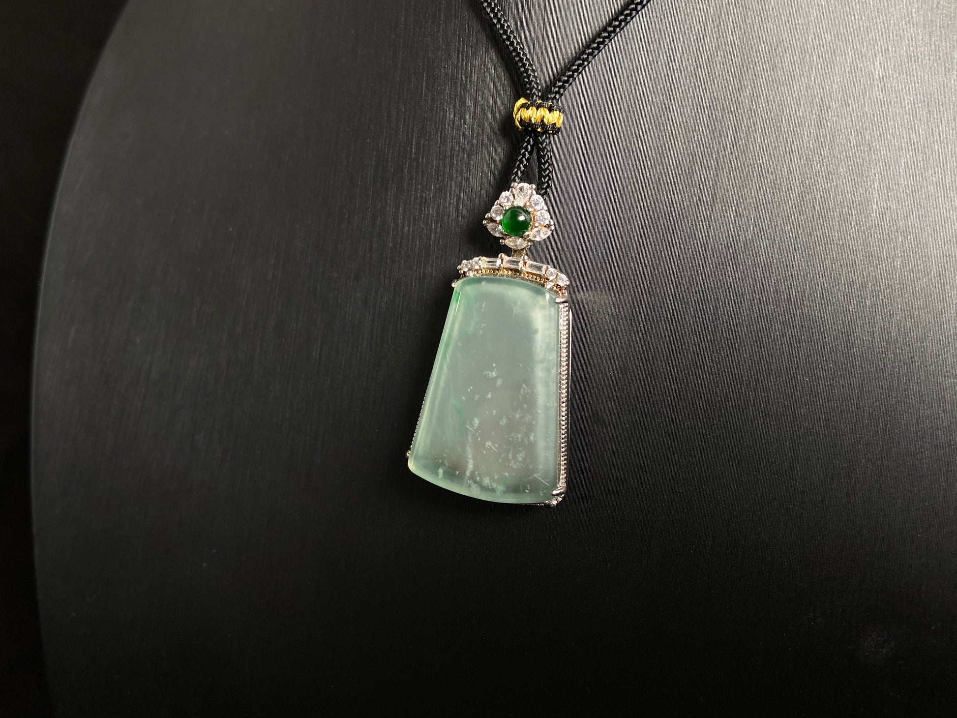 A clear light green "Wu Shi" plaque pendant, framed in 925 silver.