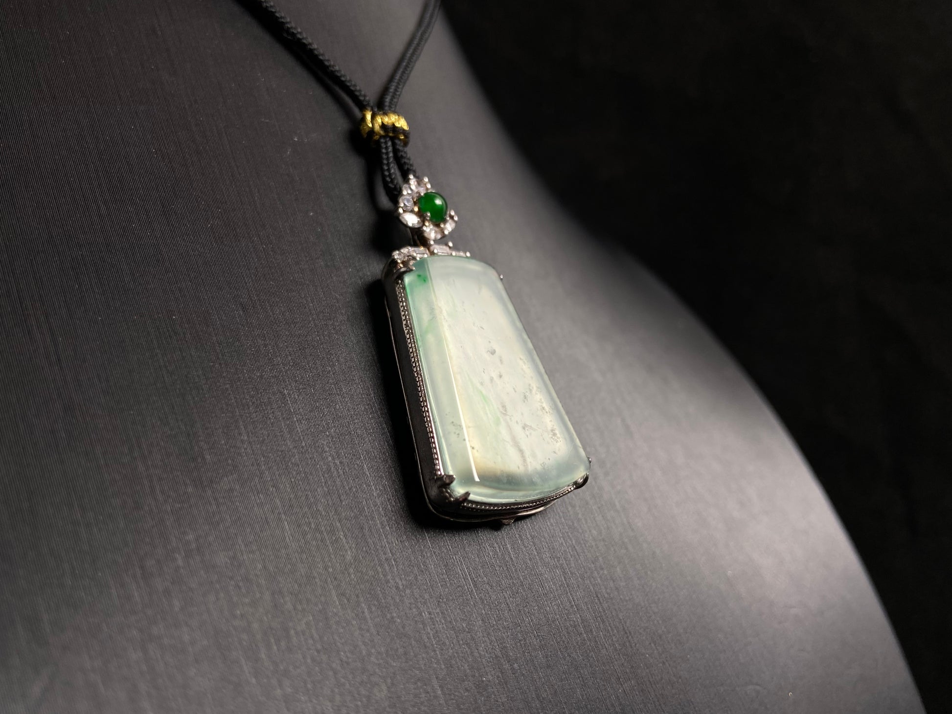 A clear light green "Wu Shi" plaque pendant, framed in 925 silver.