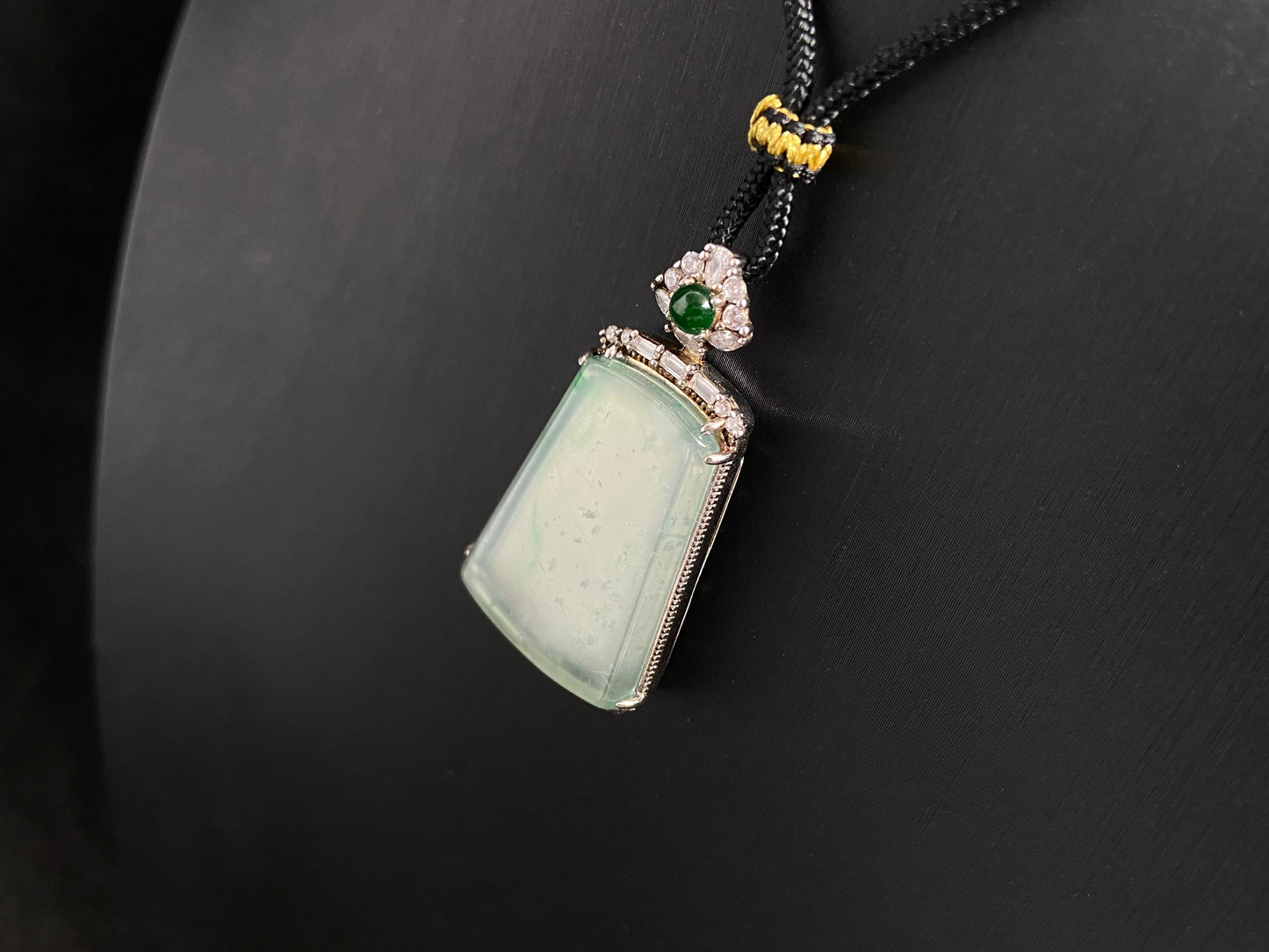 A clear light green "Wu Shi" plaque pendant, framed in 925 silver.