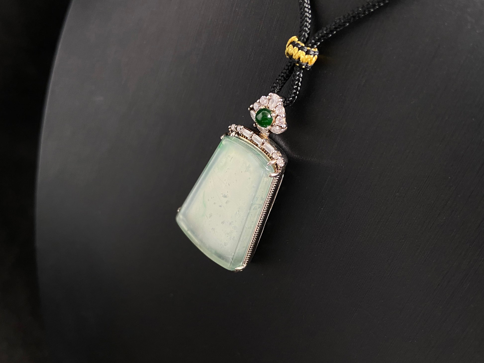 A clear light green "Wu Shi" plaque pendant, framed in 925 silver.