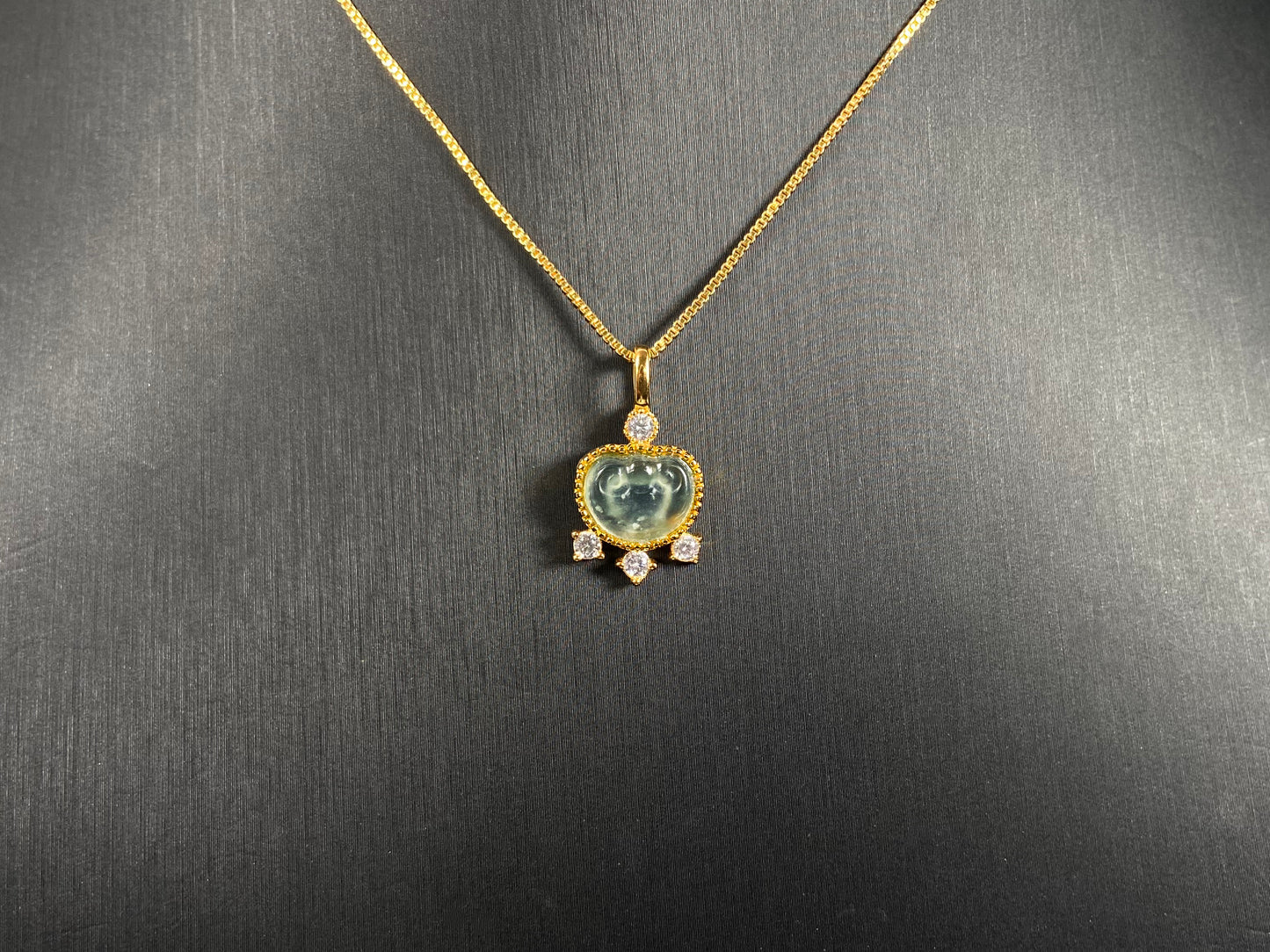 An icy jadeite ingot pendant with gold-plated 925 silver edges, set with three diamonds at the base and one on top.