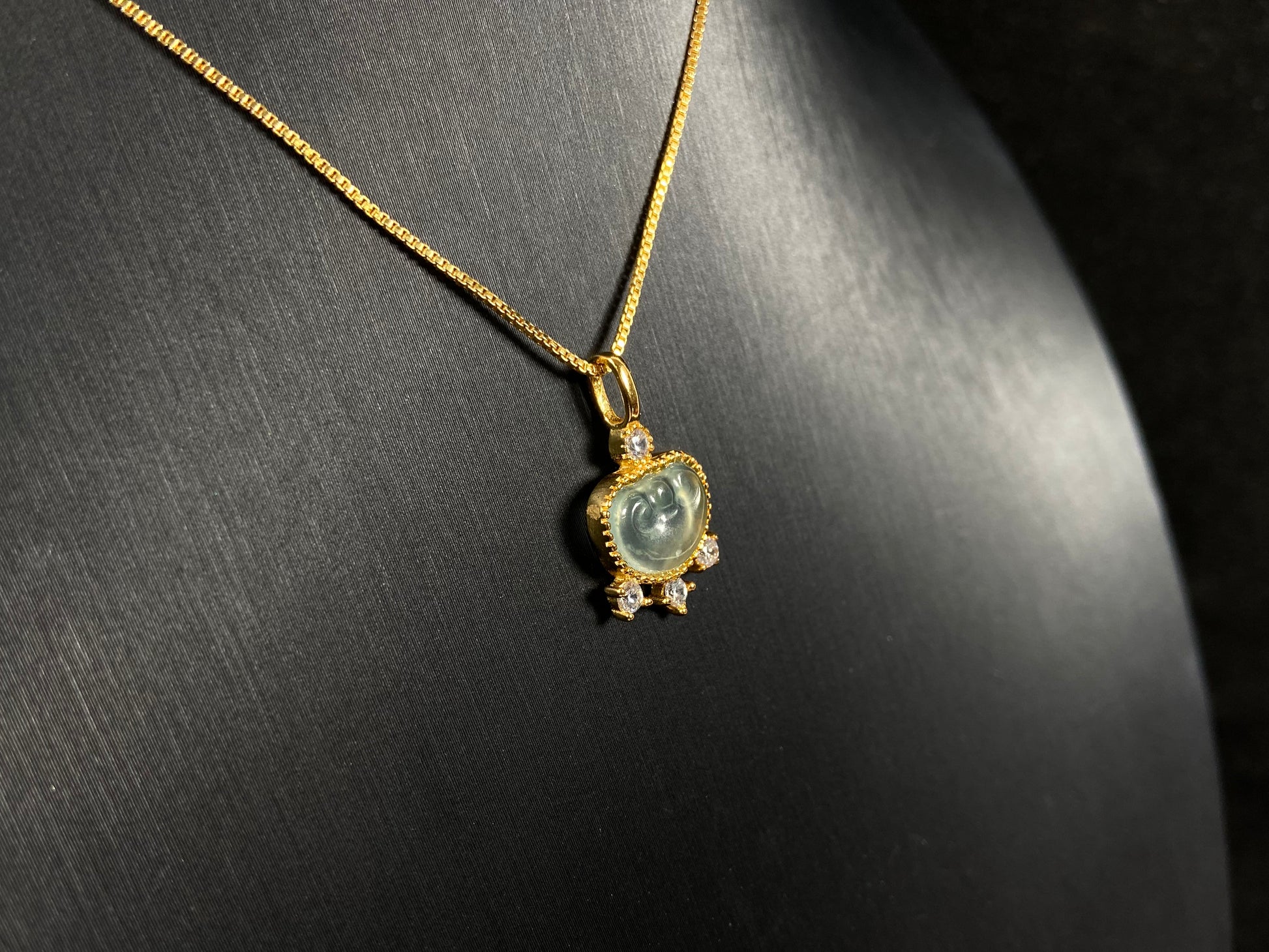 An icy jadeite ingot pendant with gold-plated 925 silver edges, set with three diamonds at the base and one on top.