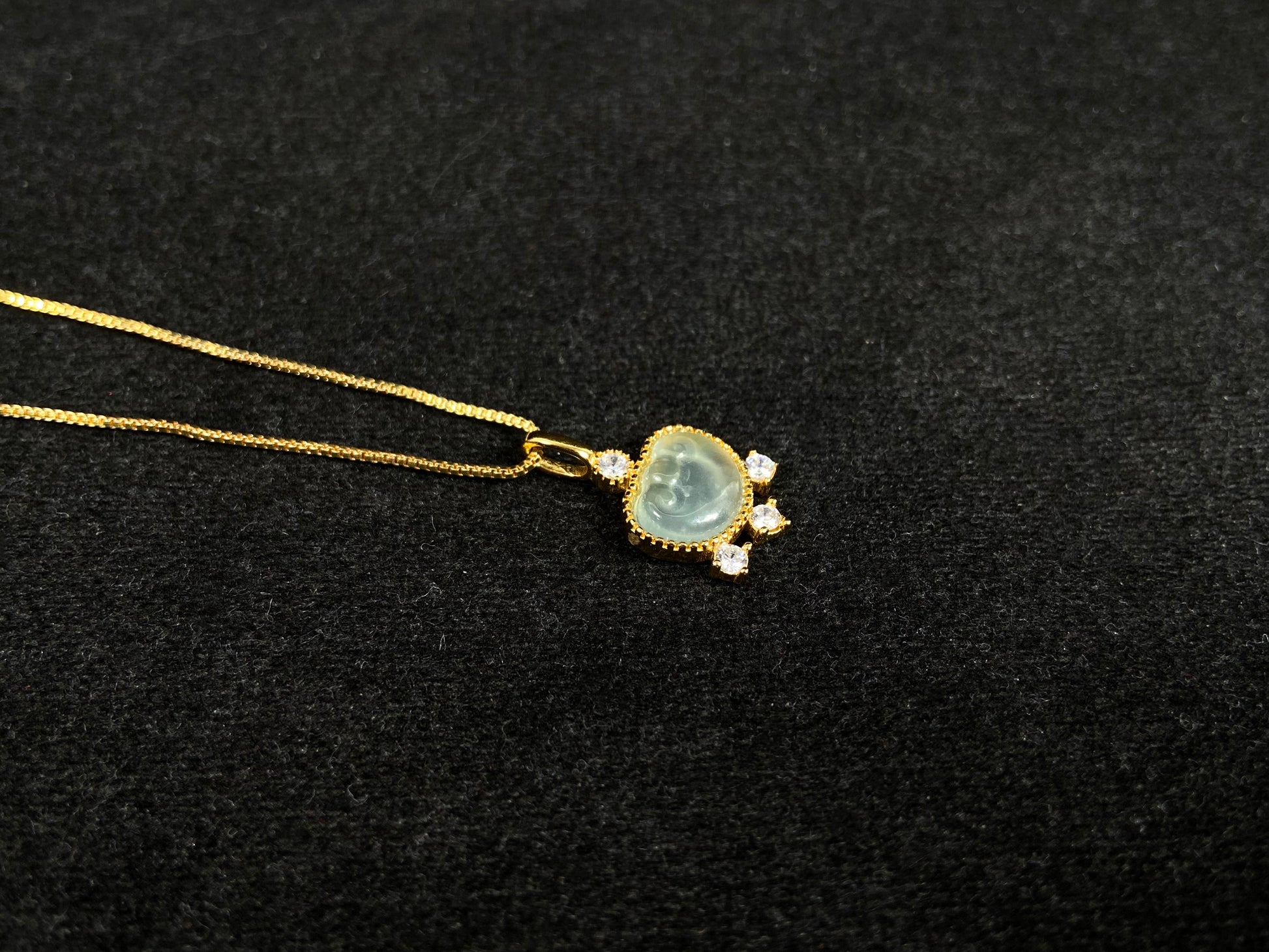 An icy jadeite ingot pendant with gold-plated 925 silver edges, set with three diamonds at the base and one on top.