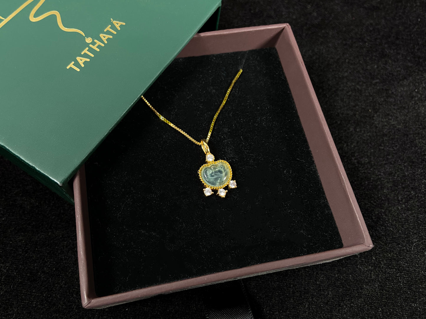 An icy jadeite ingot pendant with gold-plated 925 silver edges, set with three diamonds at the base and one on top.
