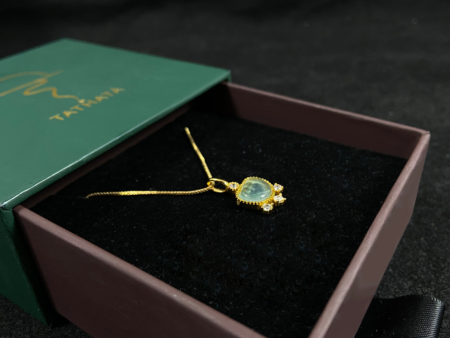 An icy jadeite ingot pendant with gold-plated 925 silver edges, set with three diamonds at the base and one on top.