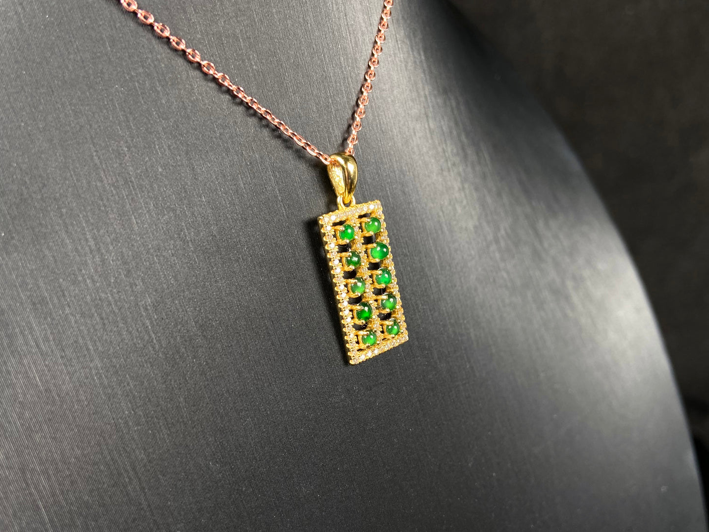 A full green square grid jadeite pendant.