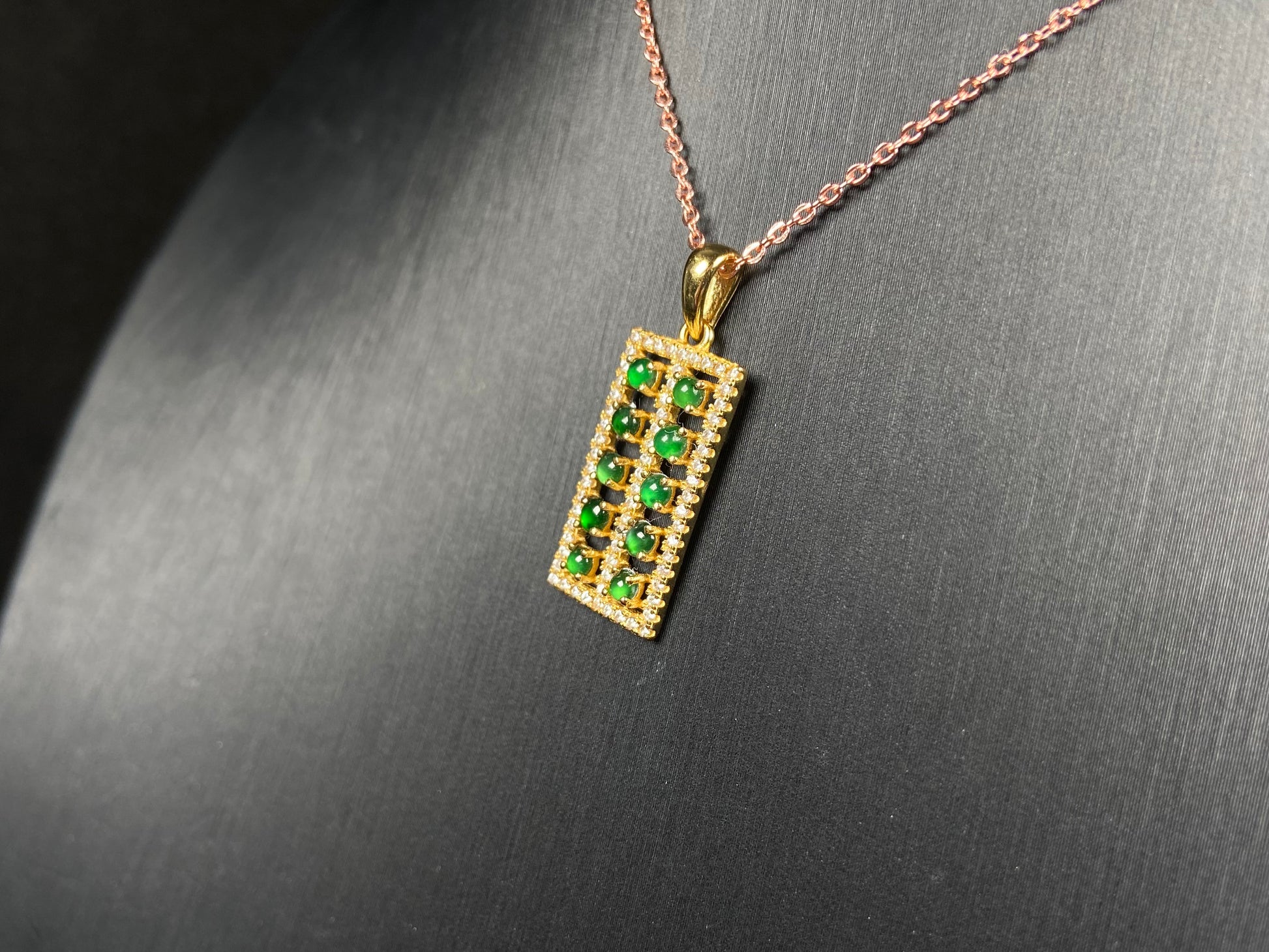 A full green square grid jadeite pendant.