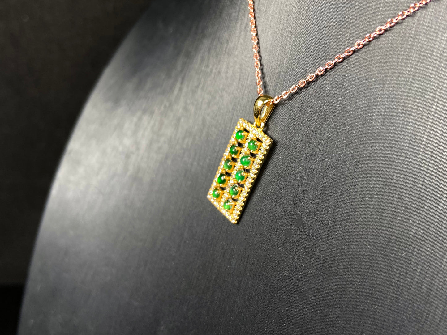 A full green square grid jadeite pendant.