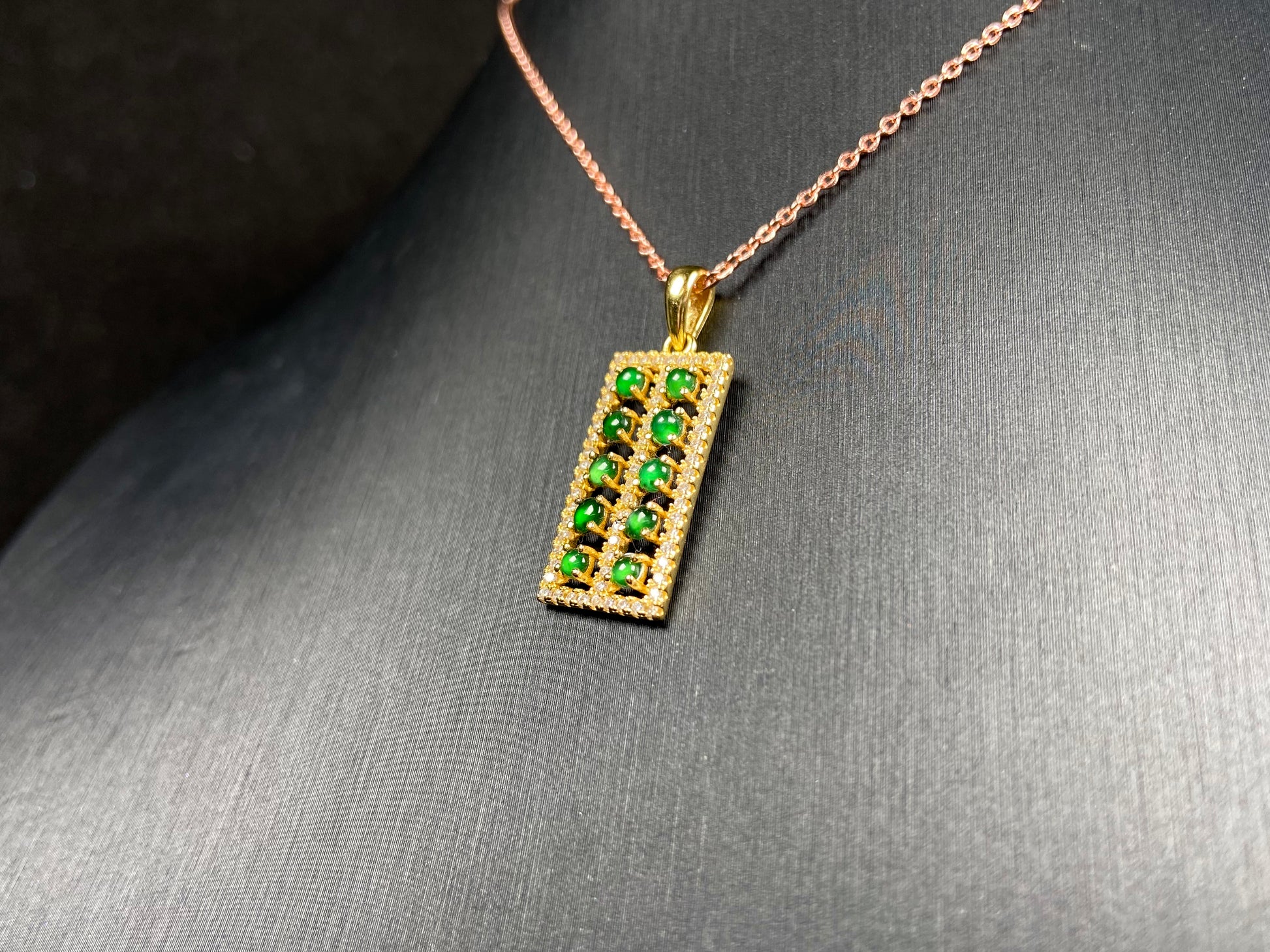 A full green square grid jadeite pendant.