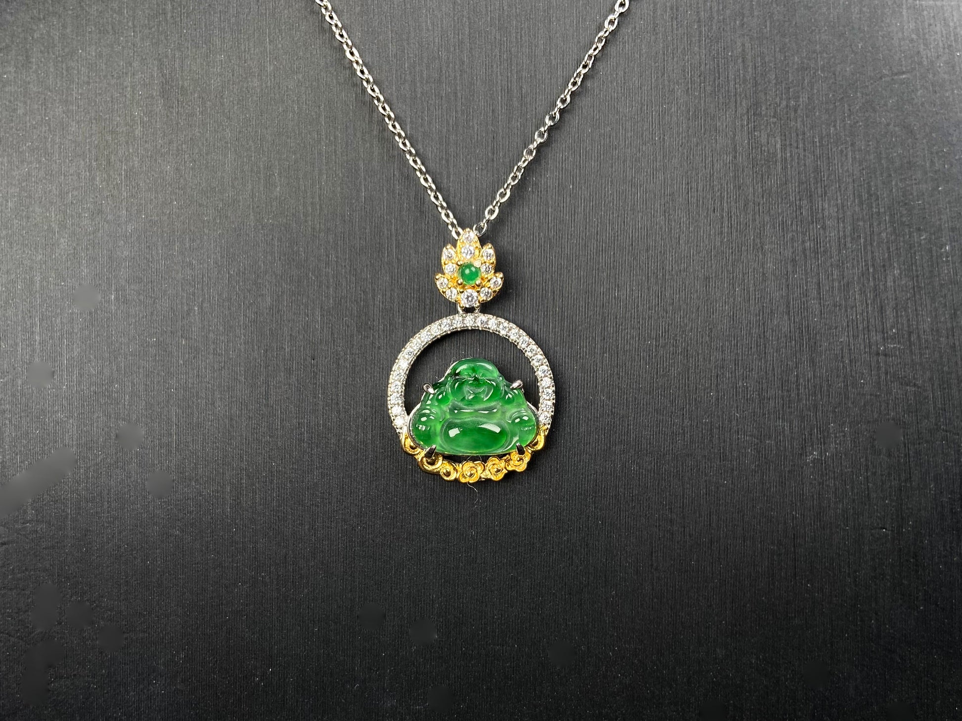 A lotus dual gold buddha jadeite pendant.
