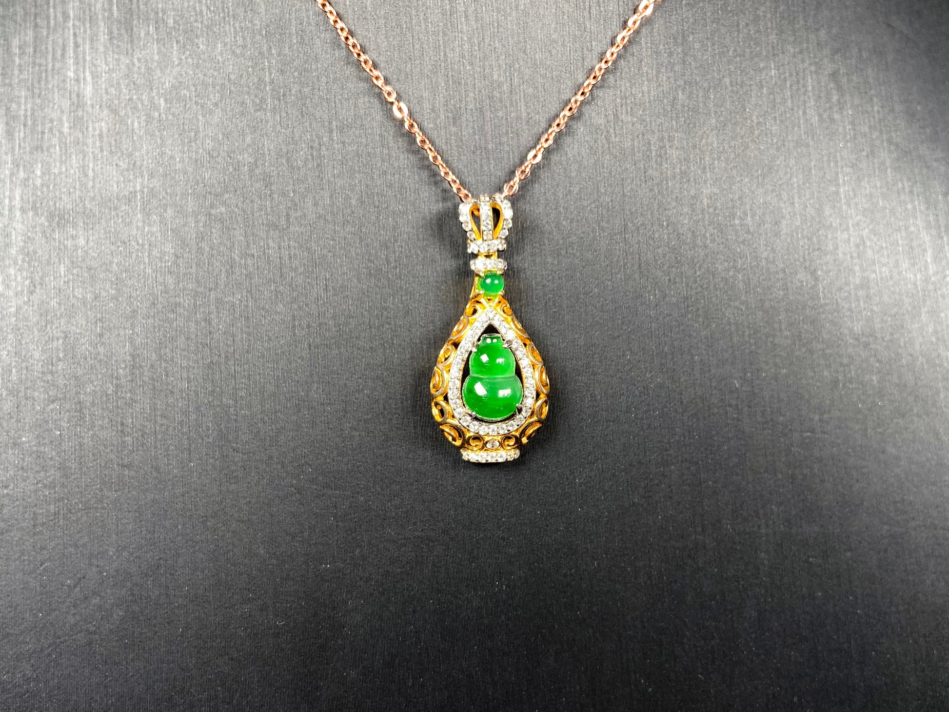 A rich green fortune gourd jadeite pendant.