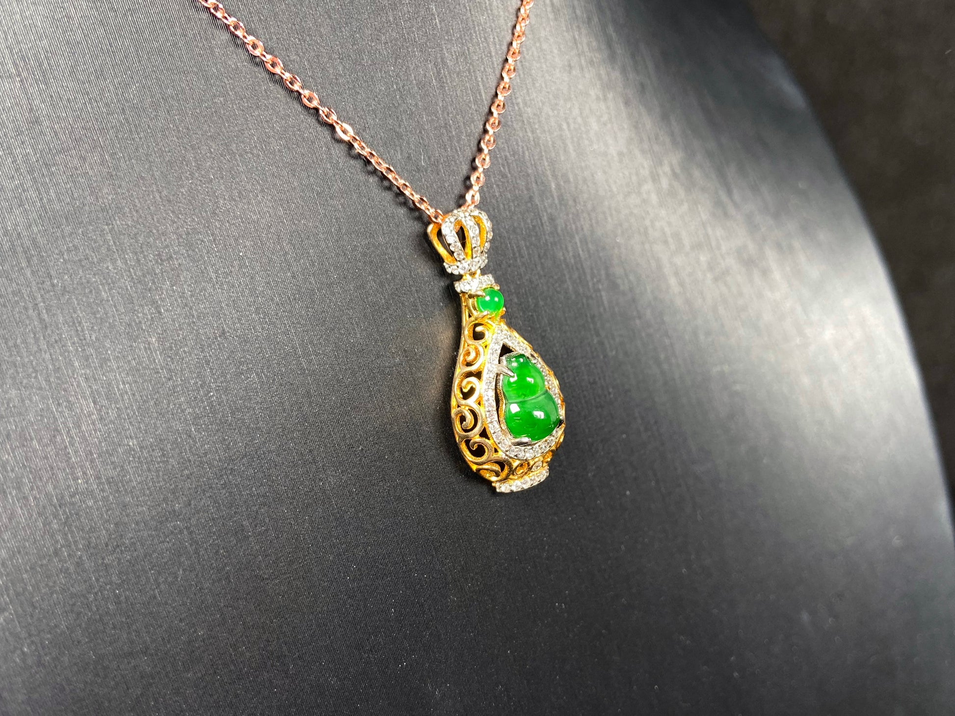 A rich green fortune gourd jadeite pendant.