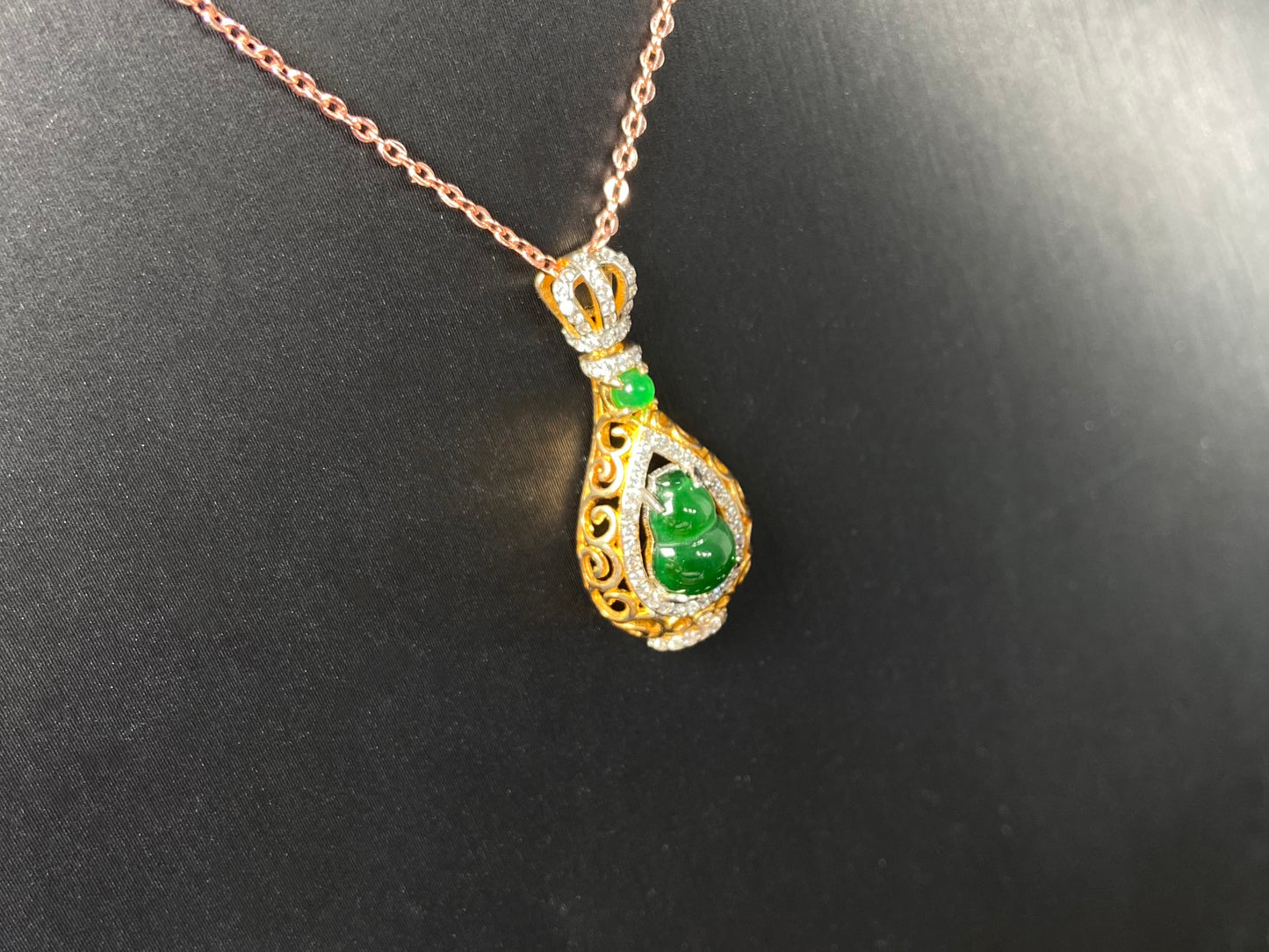 A rich green fortune gourd jadeite pendant.