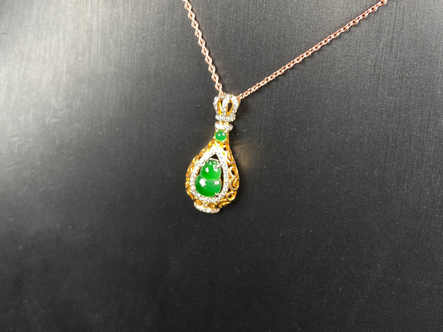 A rich green fortune gourd jadeite pendant.