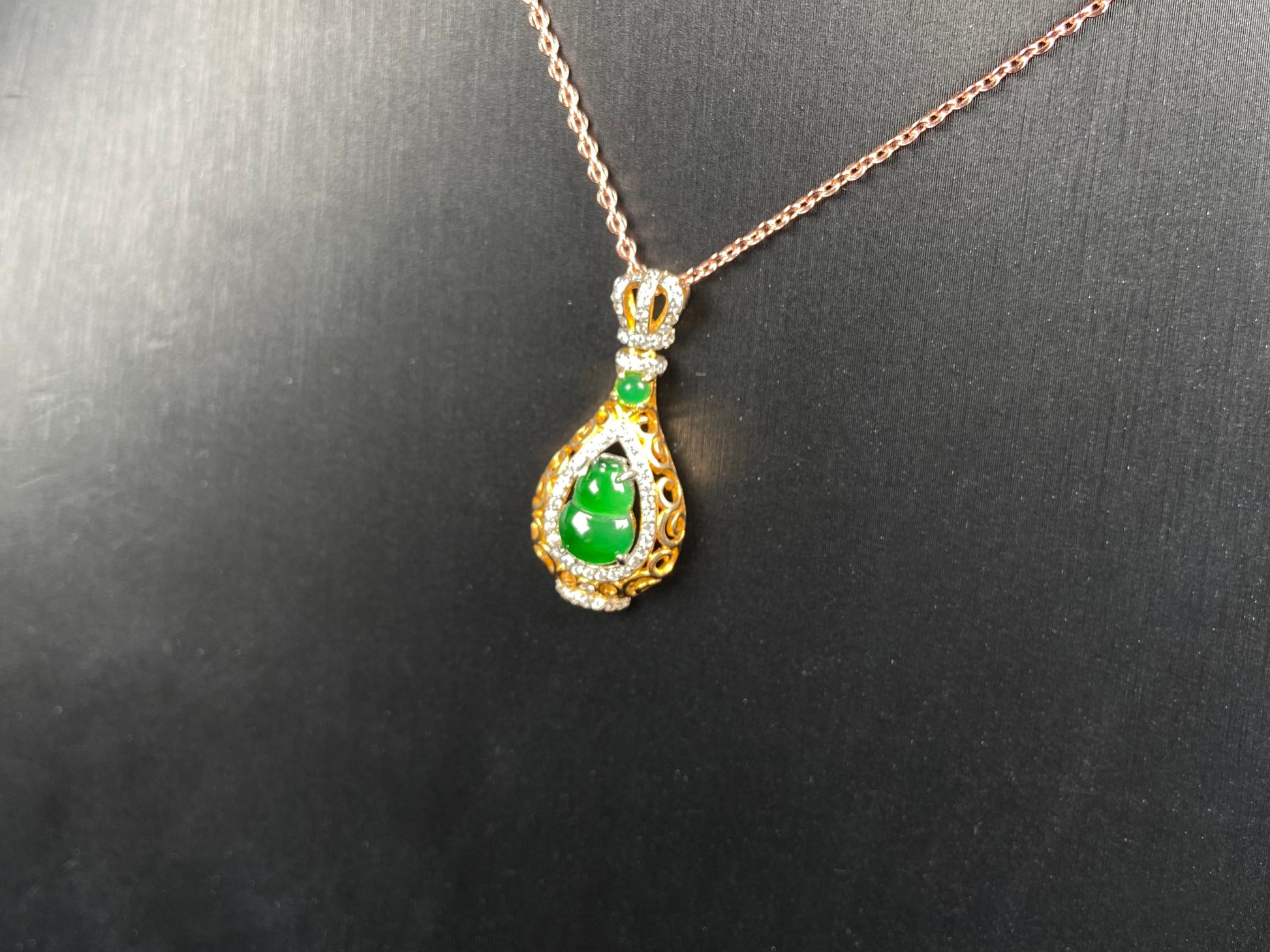 A rich green fortune gourd jadeite pendant.