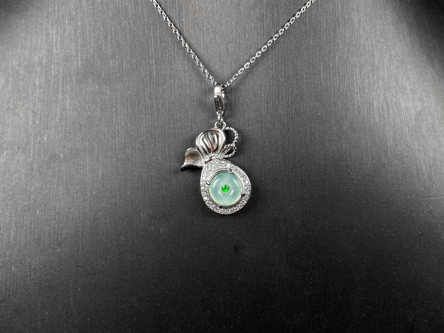 A icy green wealth pouch jadeite pendant.