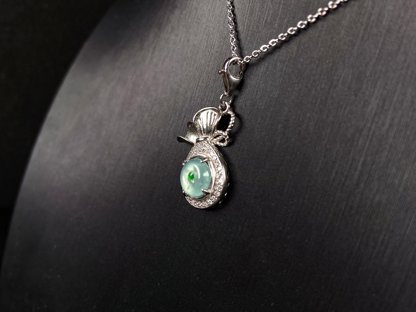 A icy green wealth pouch jadeite pendant.
