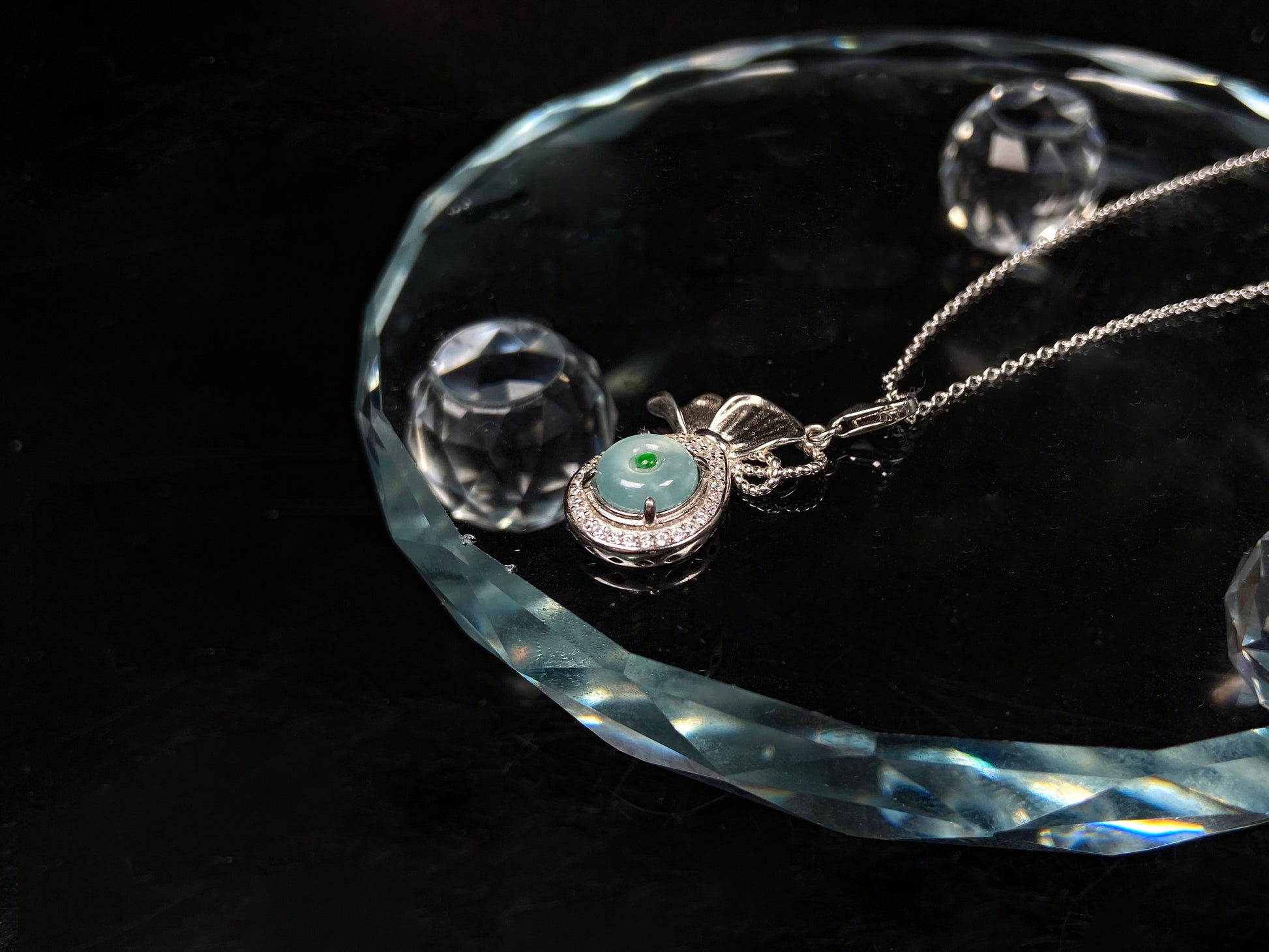 A icy green wealth pouch jadeite pendant.