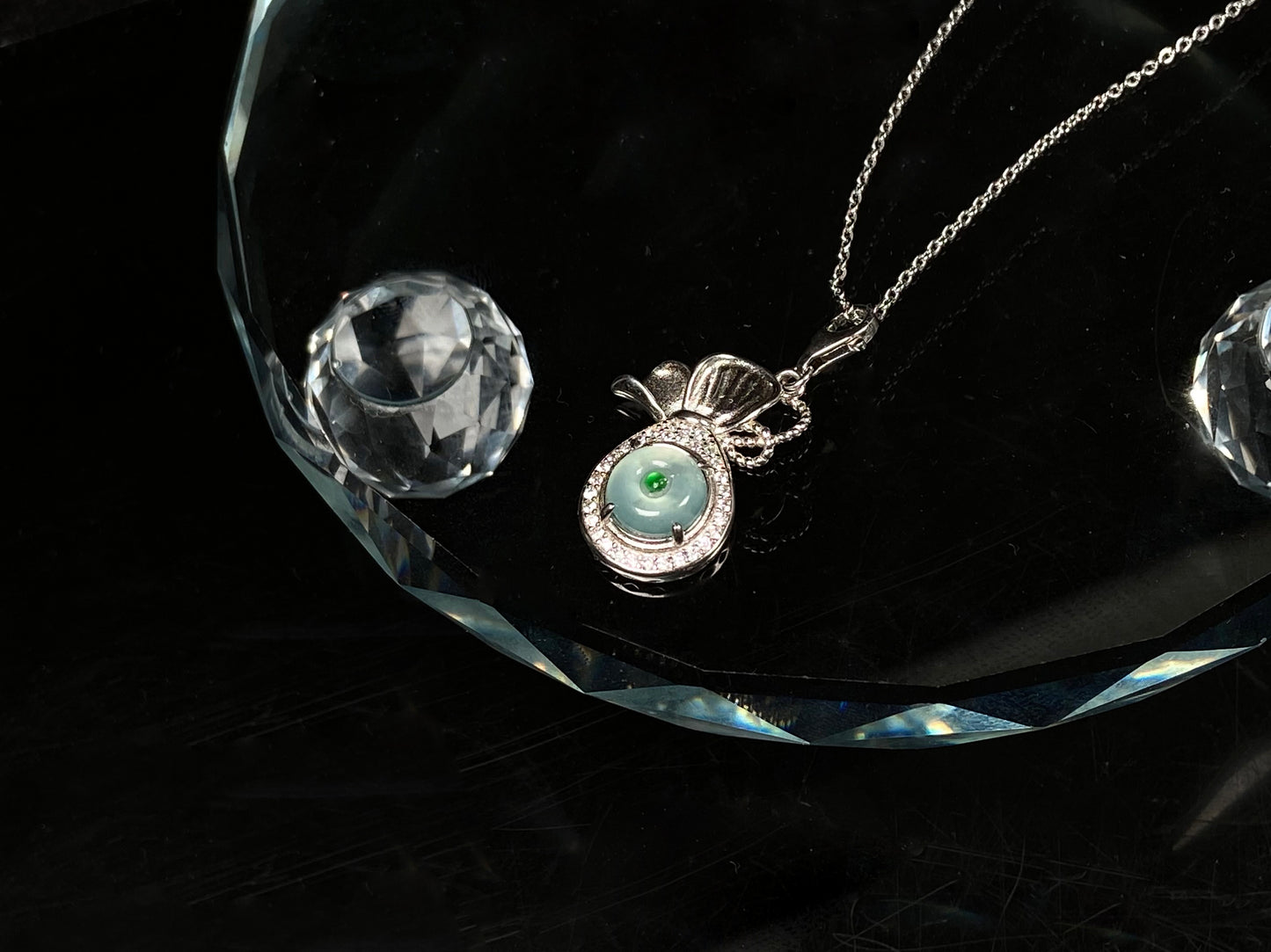 A icy green wealth pouch jadeite pendant.