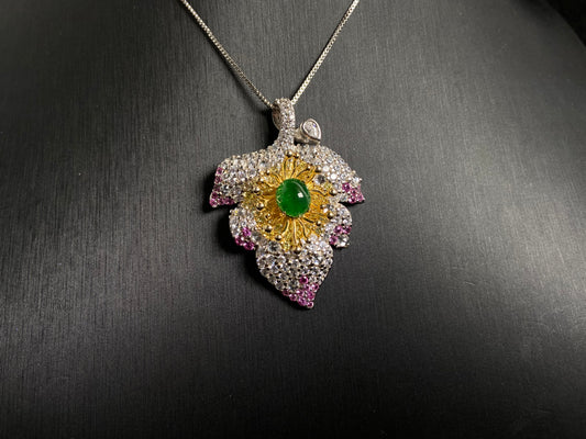 A 925 silver leaf pendant with gold and rose gold plating, centered with an imperial green jade bead.