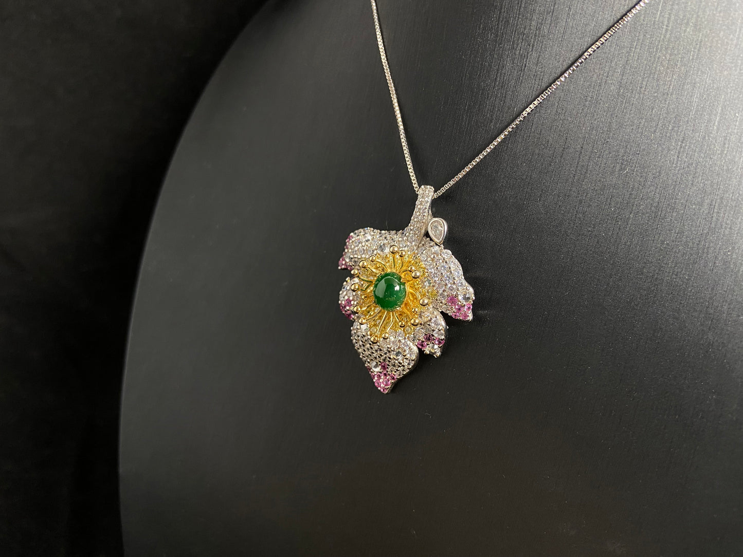 A 925 silver leaf pendant with gold and rose gold plating, centered with an imperial green jade bead.