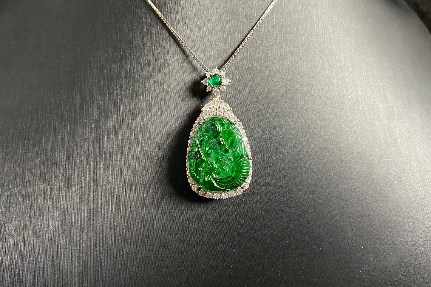 A green jade phoenix, symbolizing good fortune and prosperity, elegantly set in 925 silver.