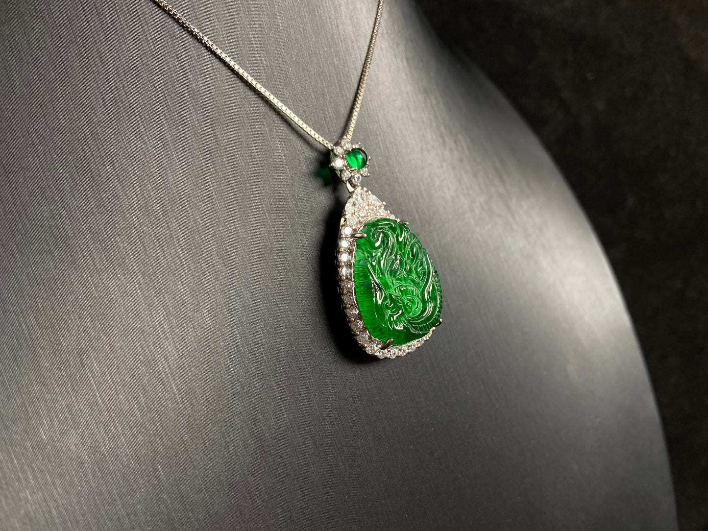 A green jade phoenix, symbolizing good fortune and prosperity, elegantly set in 925 silver.