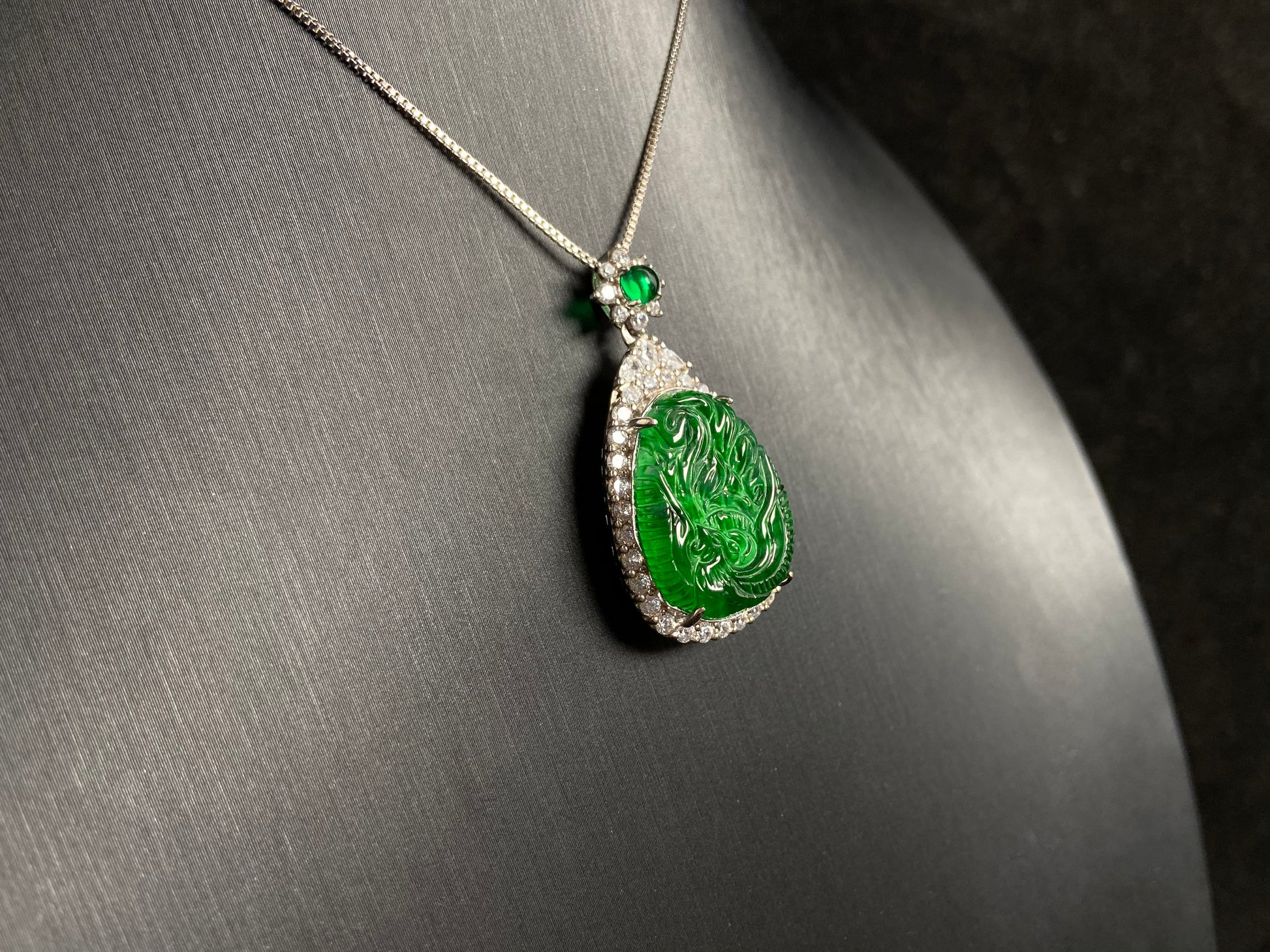 A green jade phoenix, symbolizing good fortune and prosperity, elegantly set in 925 silver.