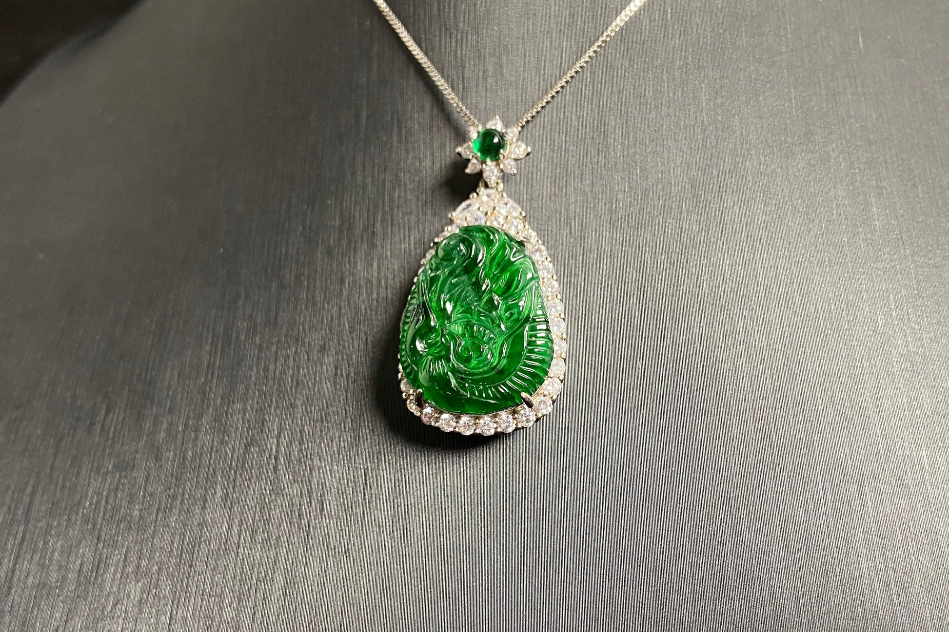 A green jade phoenix, symbolizing good fortune and prosperity, elegantly set in 925 silver.