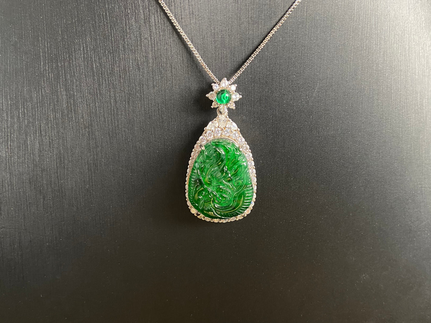 A green jade phoenix, symbolizing good fortune and prosperity, elegantly set in 925 silver.
