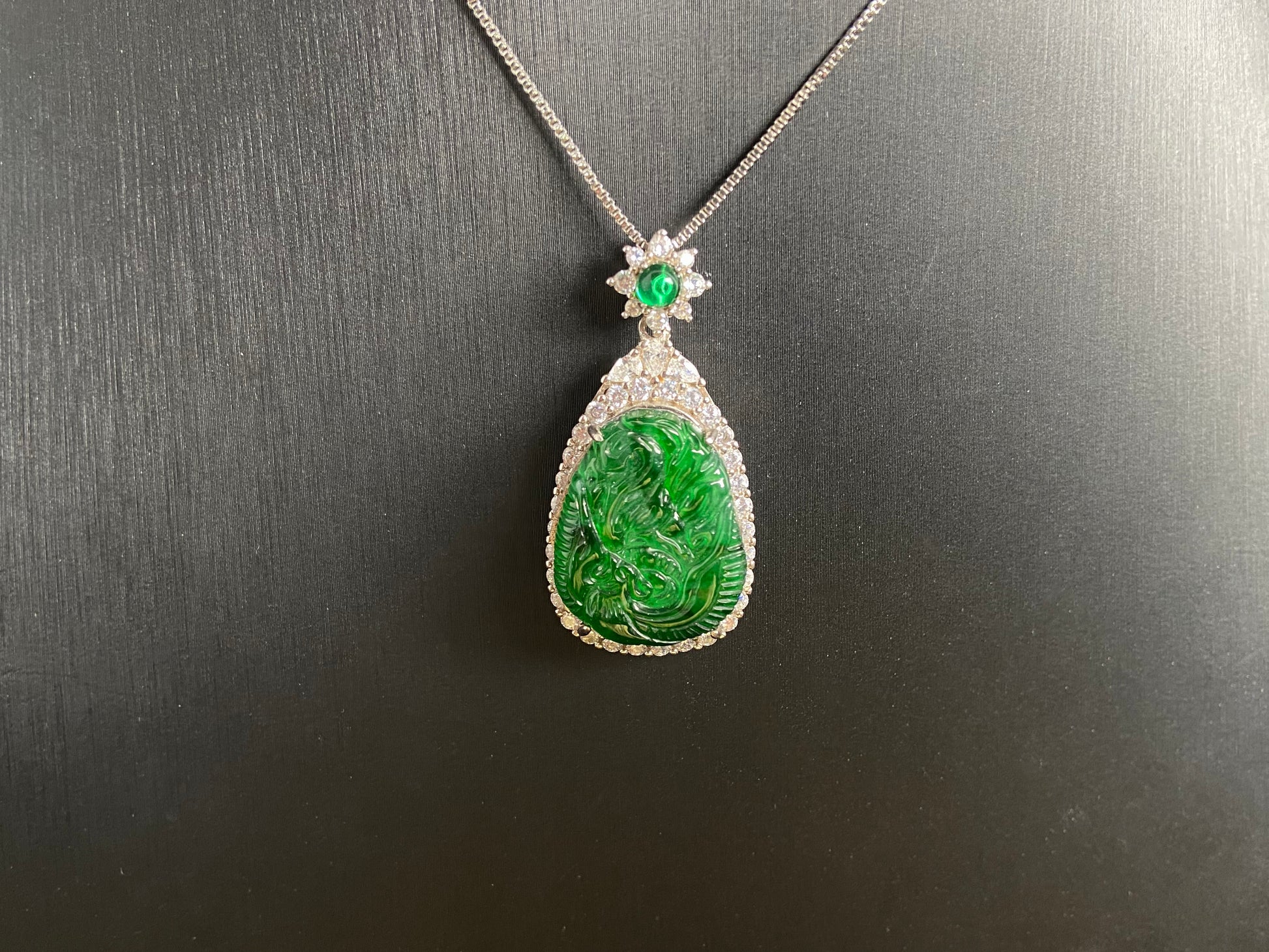A green jade phoenix, symbolizing good fortune and prosperity, elegantly set in 925 silver.