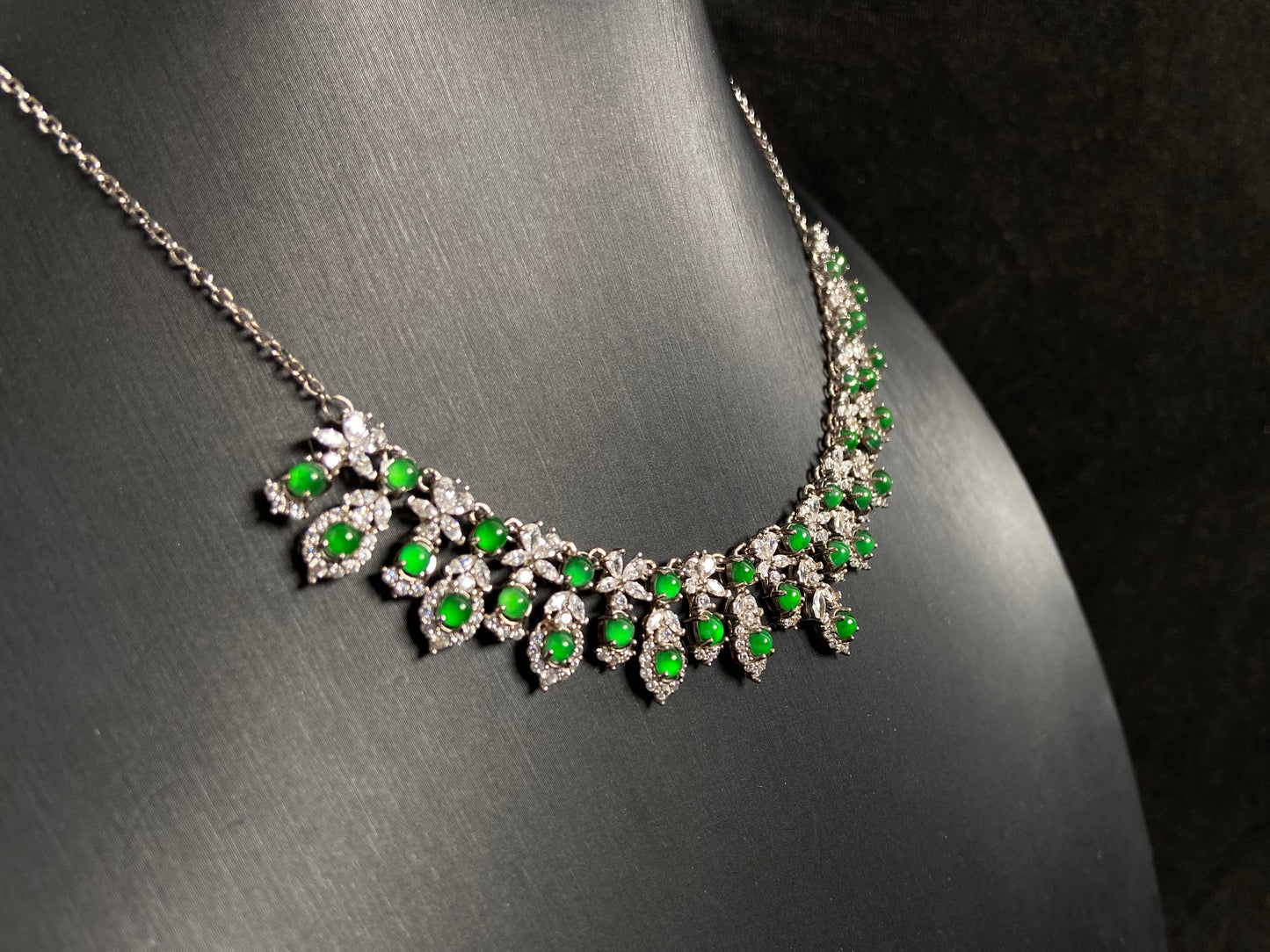 A fox shaped pendant featuring 34 imperial green translucent jade beads with 925 silver petal and leaf accents.