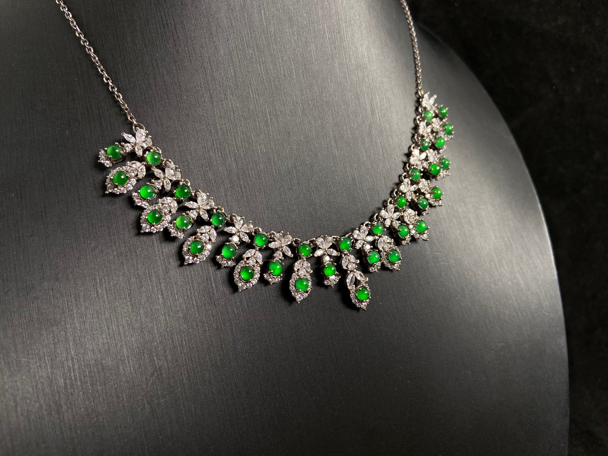 A fox shaped pendant featuring 34 imperial green translucent jade beads with 925 silver petal and leaf accents.