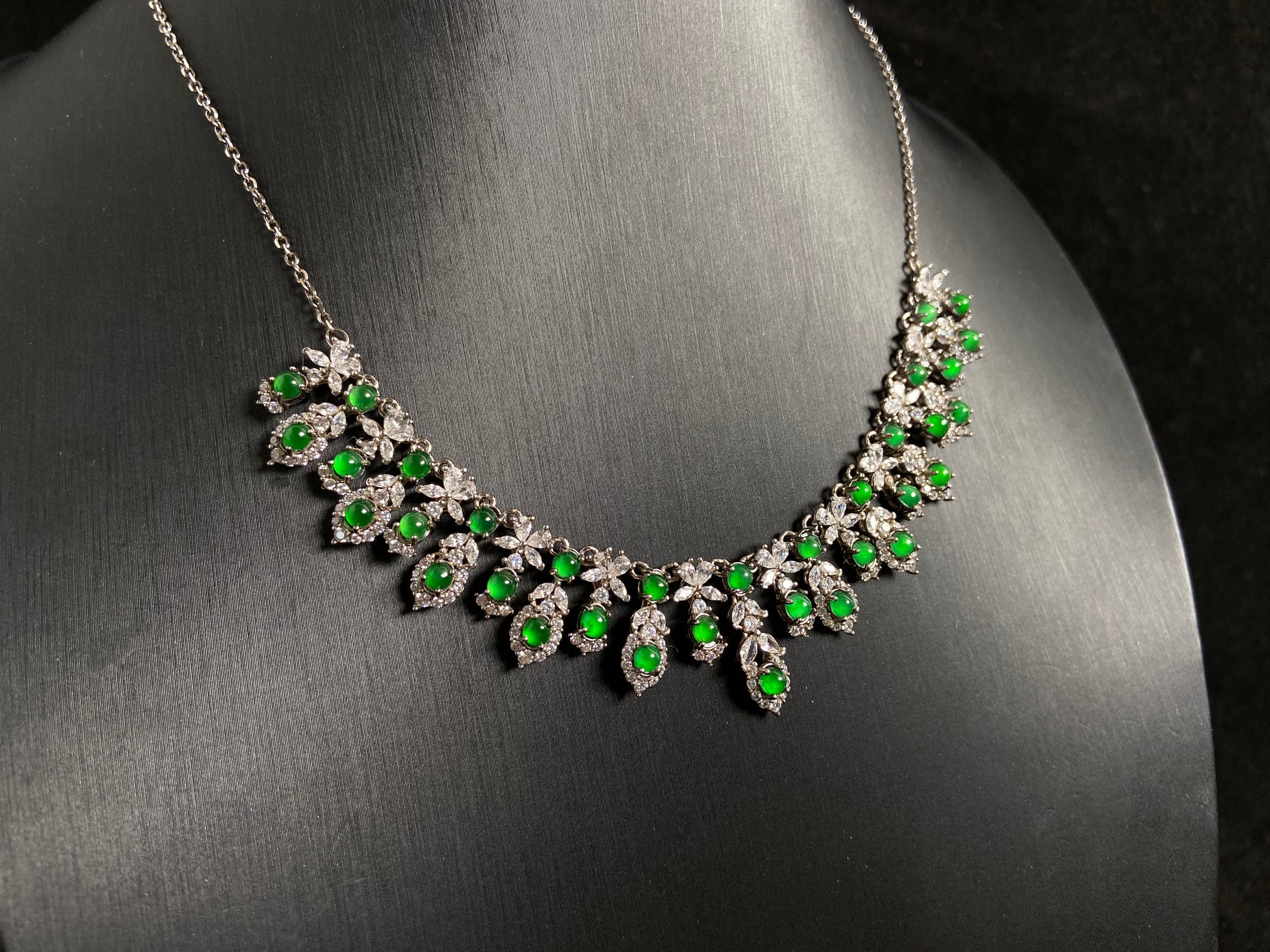 A fox shaped pendant featuring 34 imperial green translucent jade beads with 925 silver petal and leaf accents.