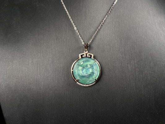 A jelly green twin fish jadeite pendant.