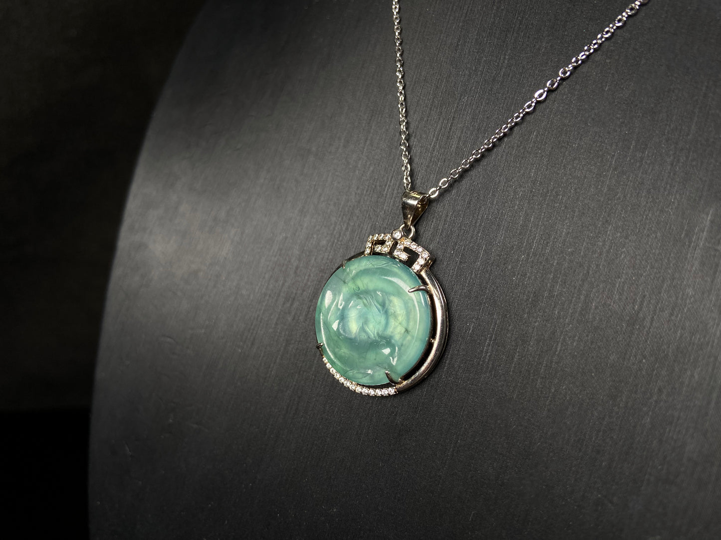 A jelly green twin fish jadeite pendant.