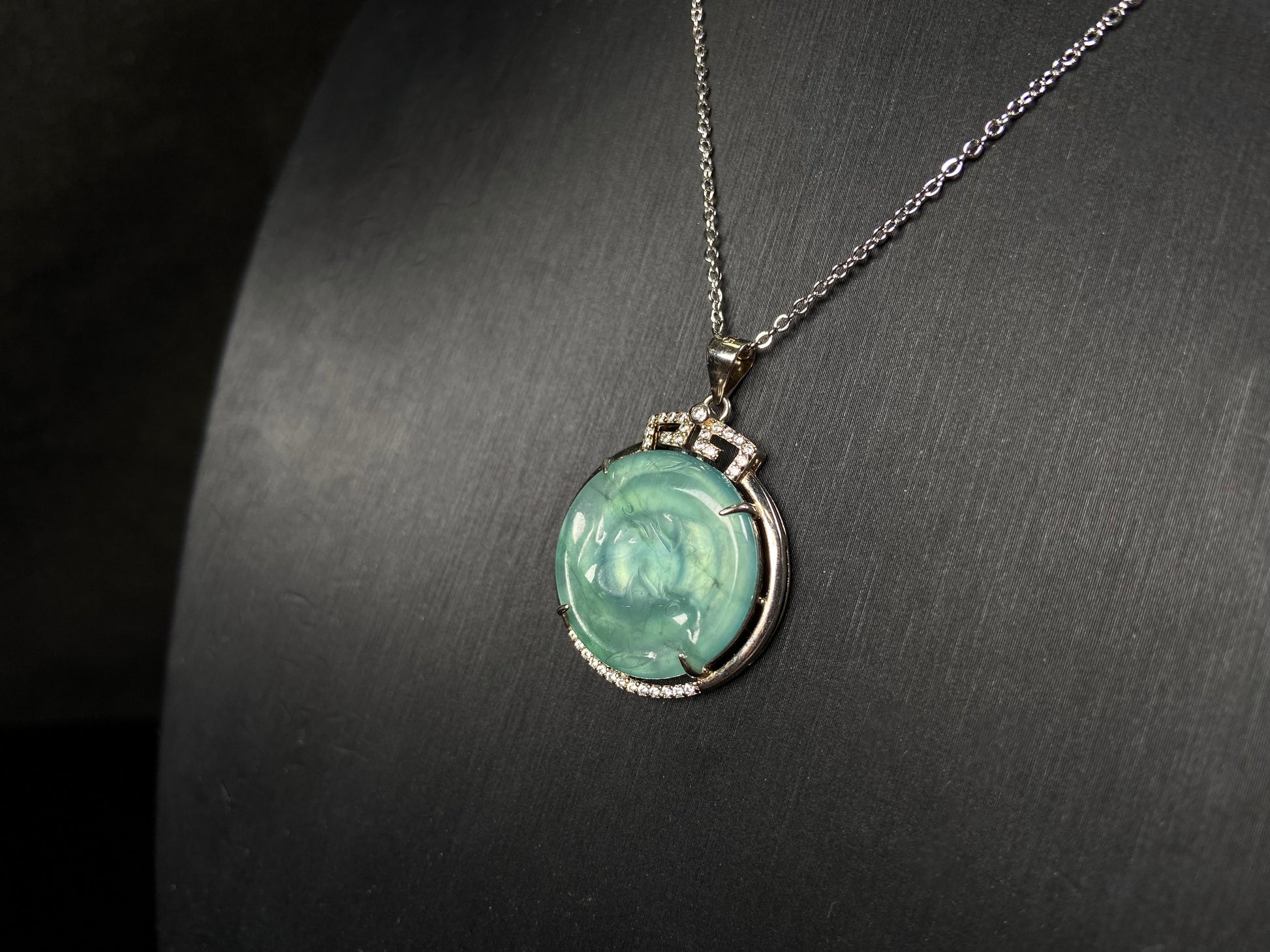 A jelly green twin fish jadeite pendant.