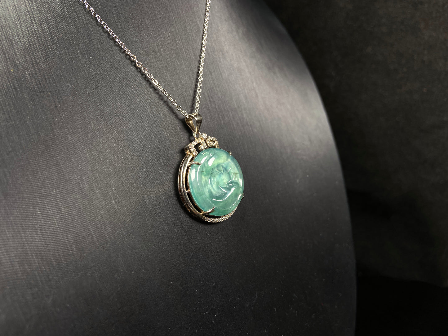 A jelly green twin fish jadeite pendant.