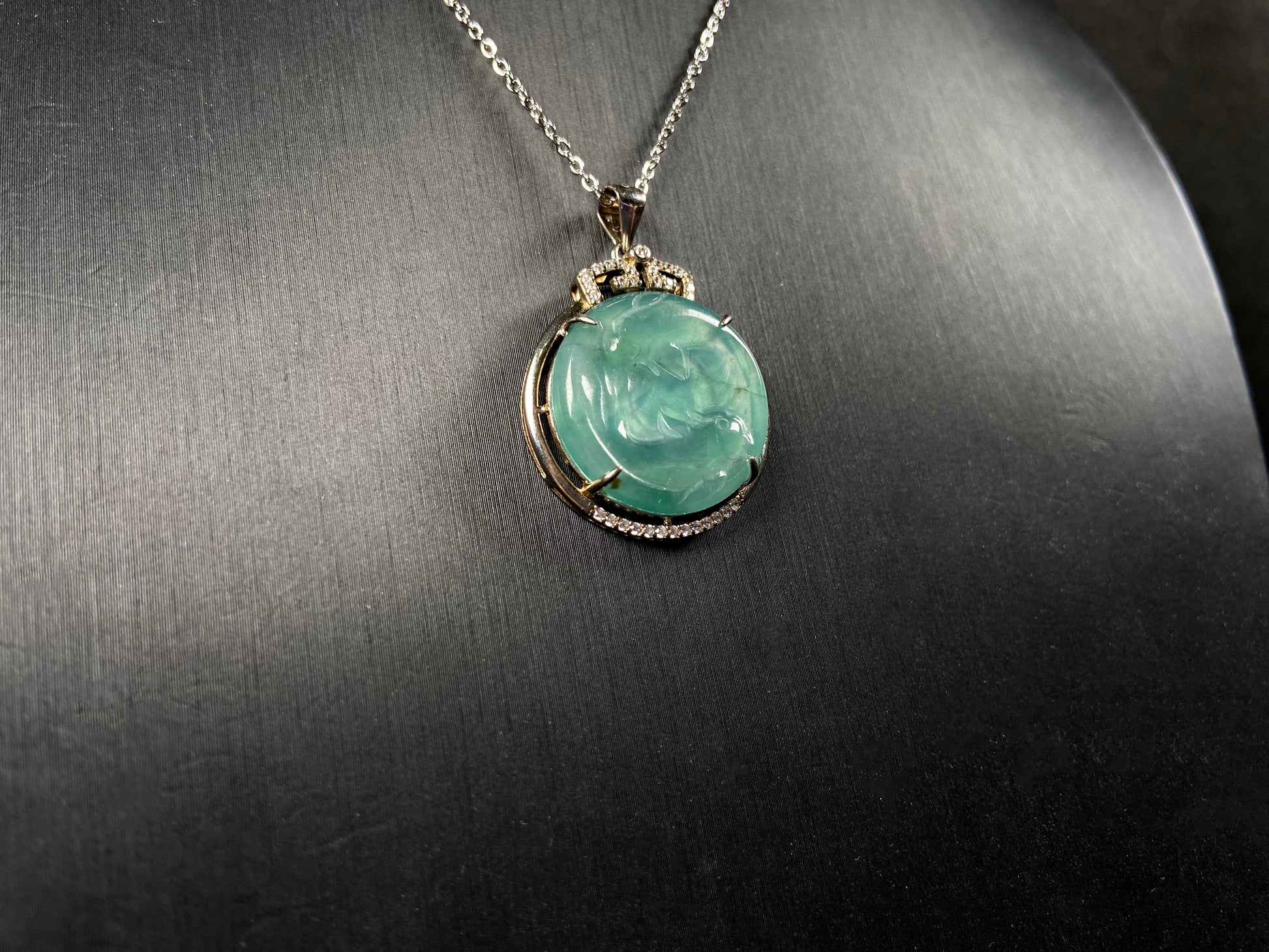 A jelly green twin fish jadeite pendant.