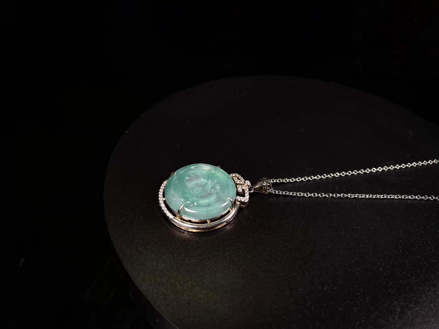 A jelly green twin fish jadeite pendant.