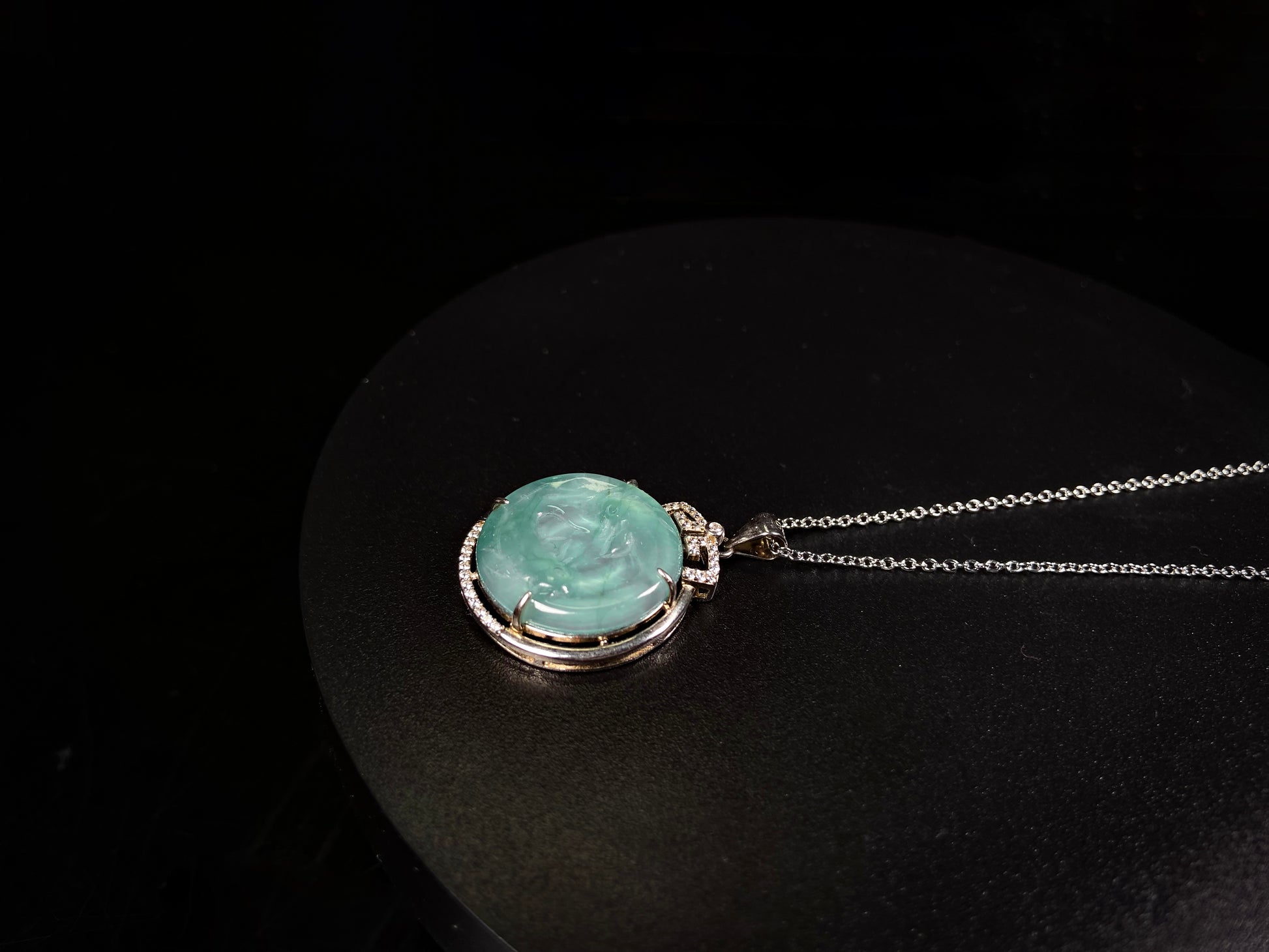 A jelly green twin fish jadeite pendant.