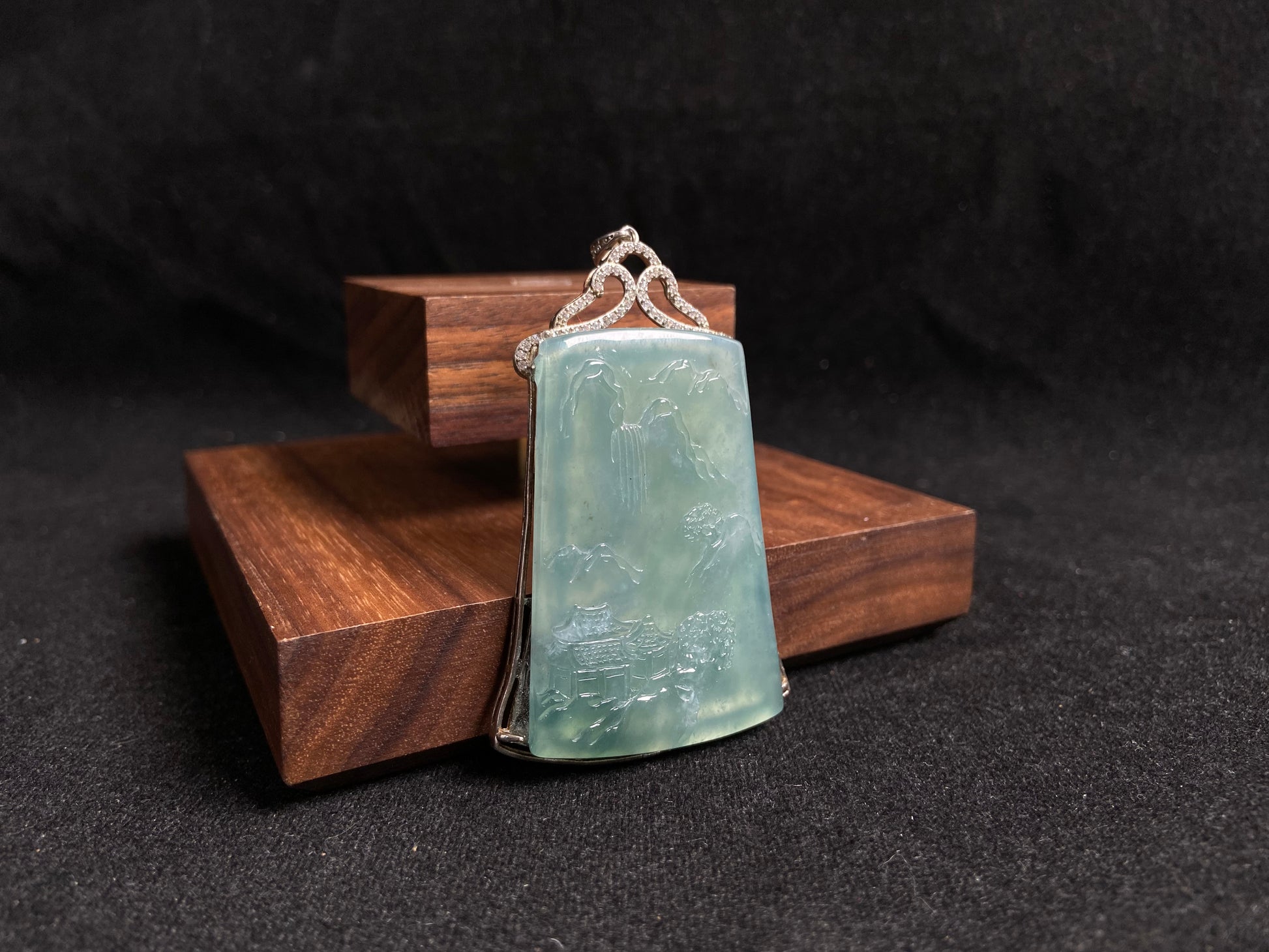 This jade pendant is a light green landscape plaque.