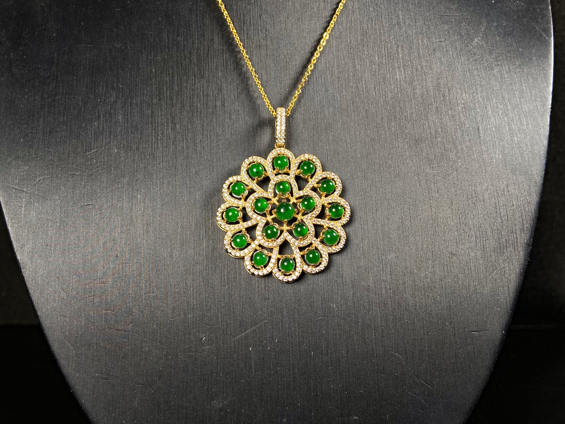 A filigree verdant cluster jadeite pendant.