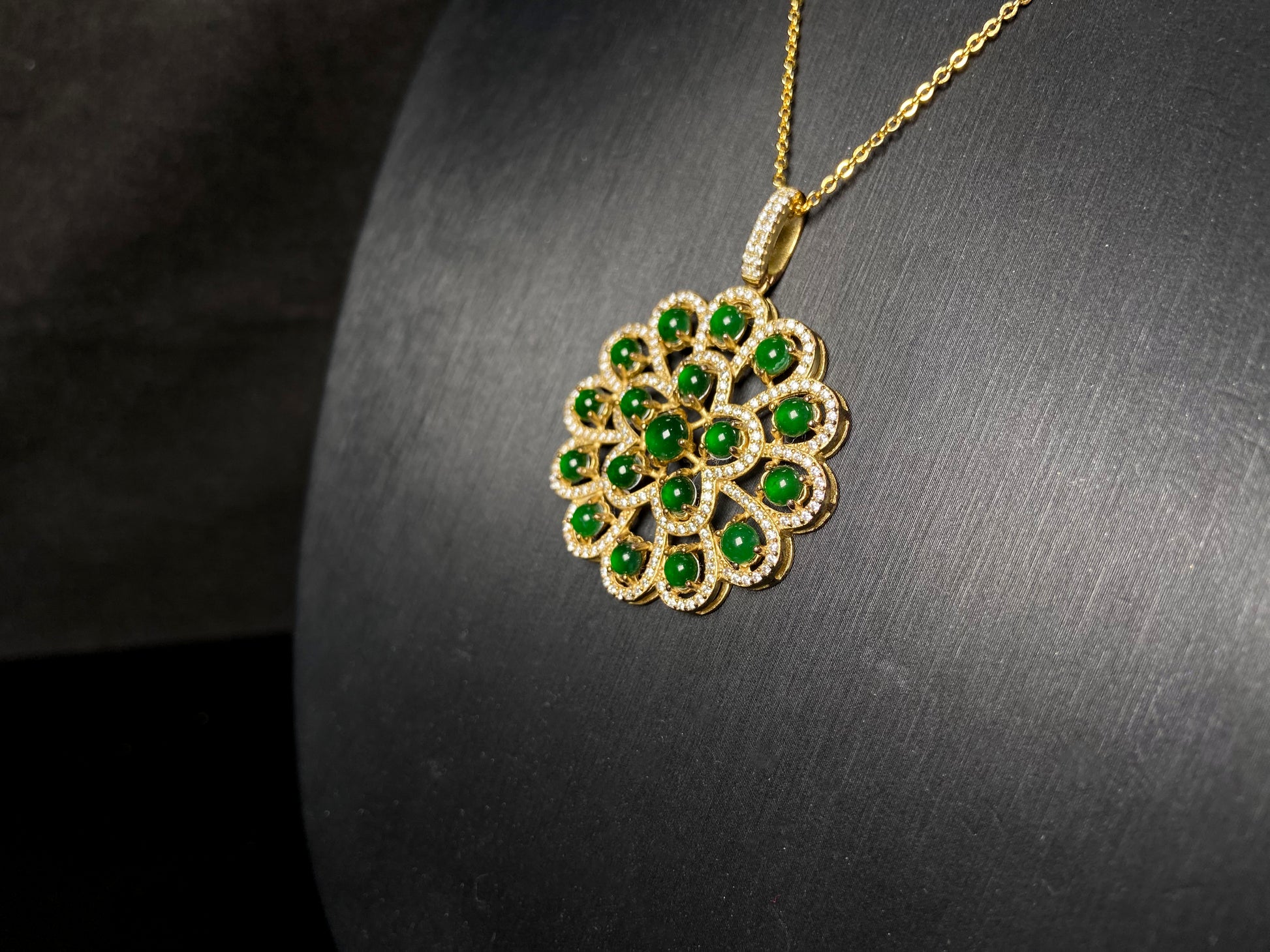 A filigree verdant cluster jadeite pendant.