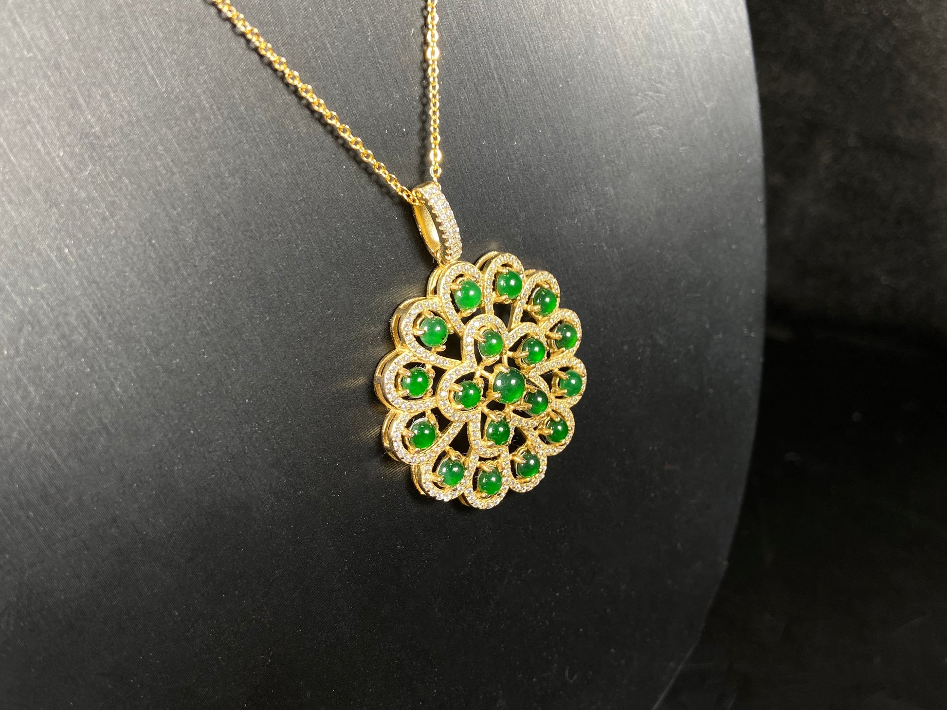 A filigree verdant cluster jadeite pendant.