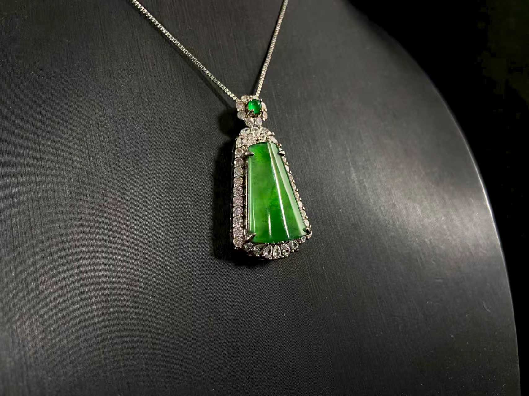 A transparent green jade “harmony plaque” symbolizing peace and freedom from worldly troubles, is elegantly framed in 925 sterling silver.