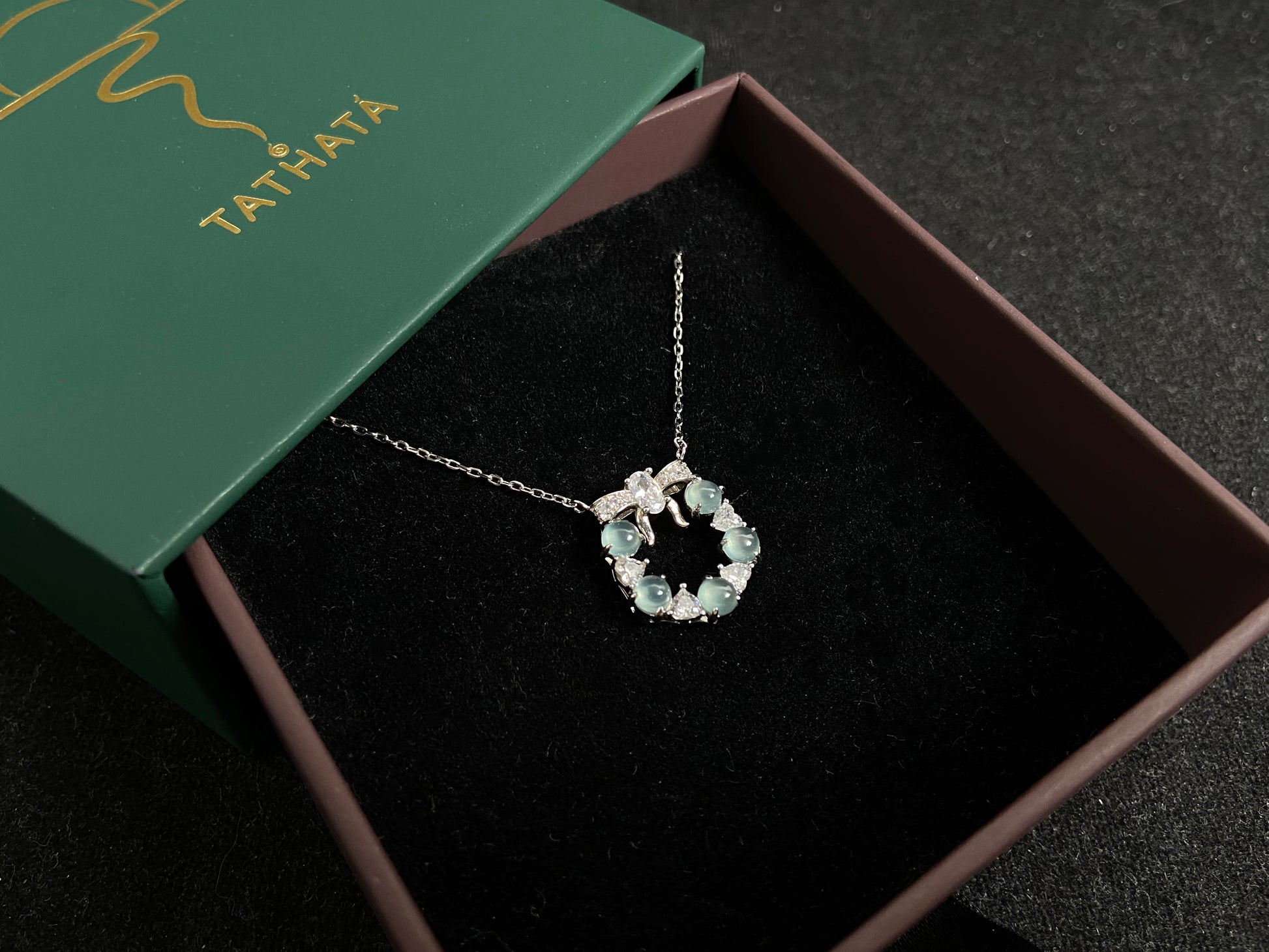 A pendant featuring five pale blue translucent jade beads, accented with diamonds and set in 925 silver.