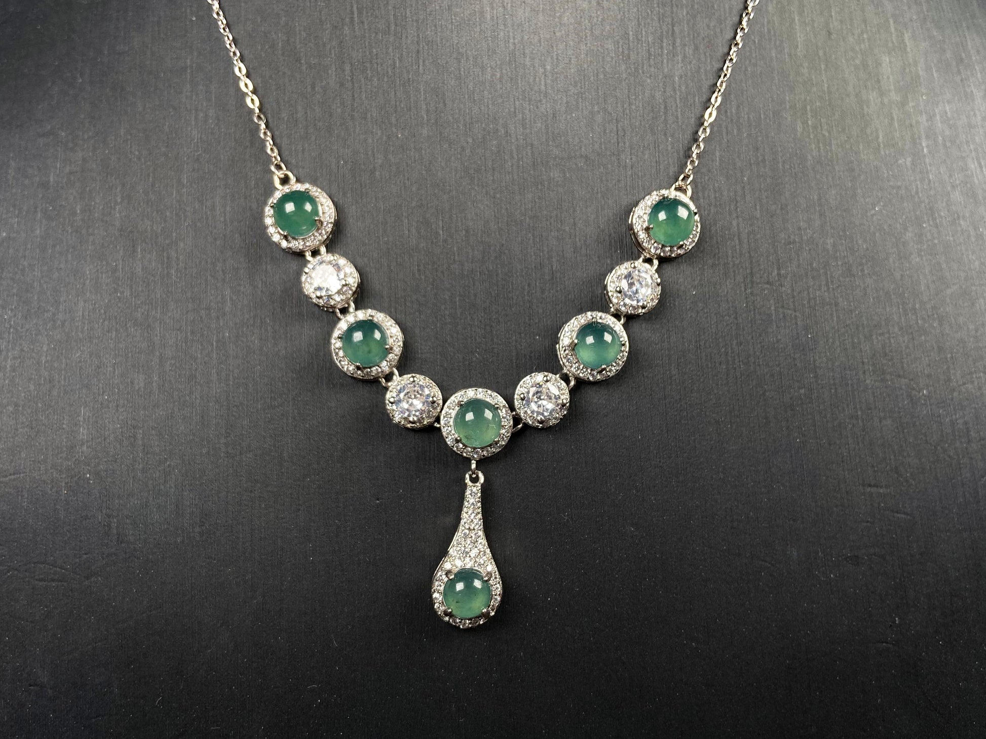 A lush green teardrop jadeite pendant.